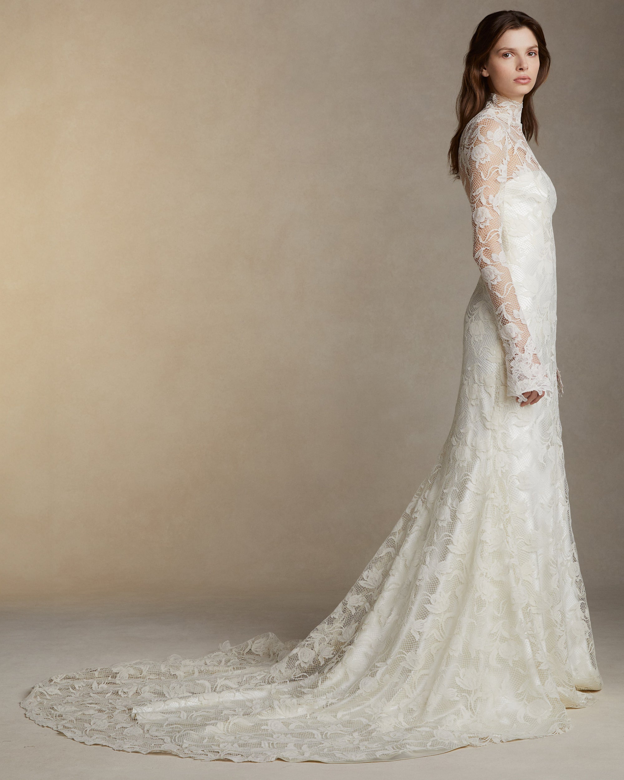 Silk wool long sleeve high neck gown with tulip lace overlay and hand cut Lyon lace appliques. Invisible zip closure at center back.