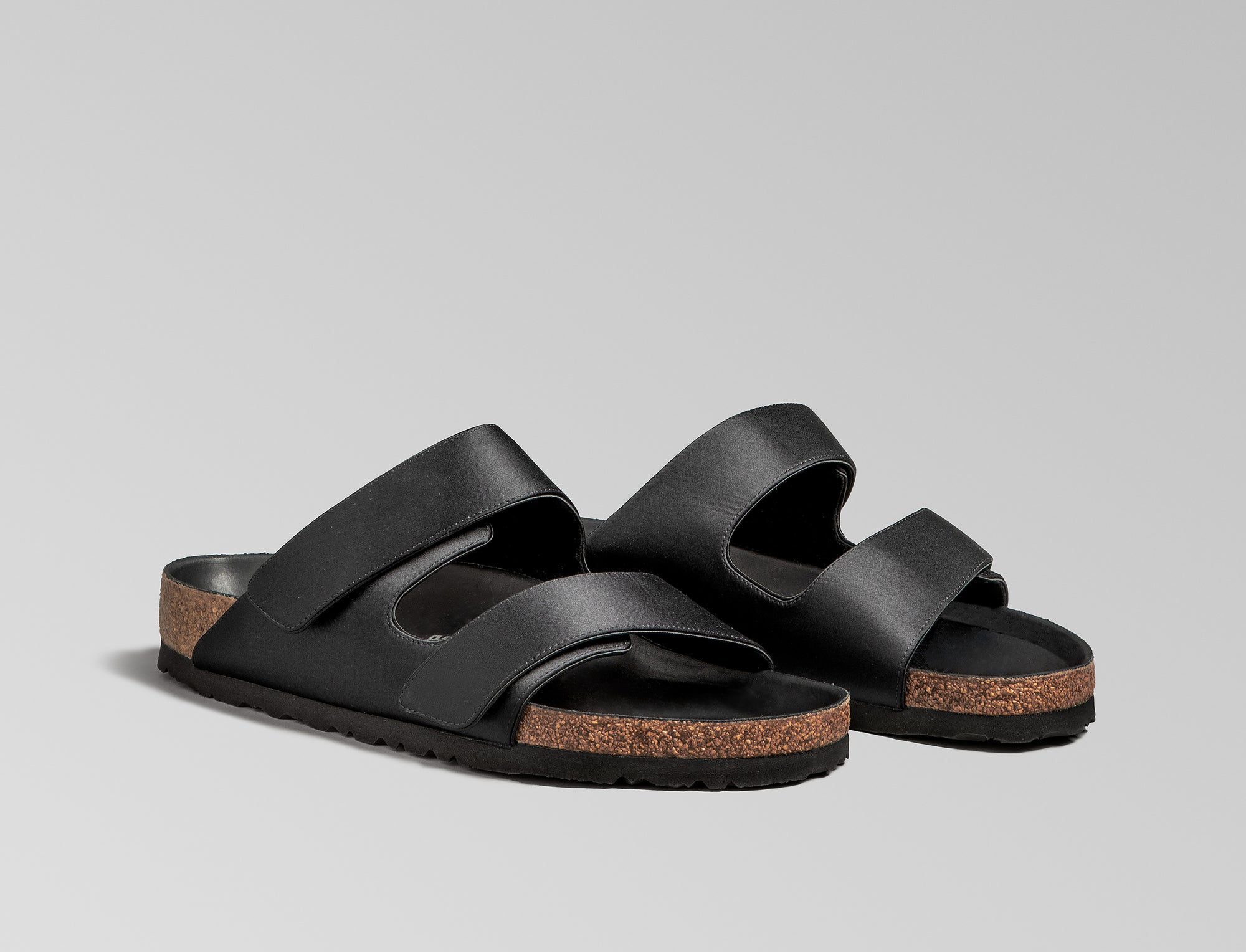 The Arizona takes a sleek turn in black satin, offering a modern, unisex design perfect for any elegant event. The design also introduces an innovative adjustable hidden buckle closure. Expertly crafted in Germany, the shoe pairs the signature BIRKENSTOCK comfort with understated sophistication through Danielle Frankel design touch. - Upper: Delicate satin upper, piped trim edge detail for premium tuxedo like finish- Footbed: Anatomical shaped BIRKENSTOCK cork latex Footbed lined with premium Nappa Leather- Sole: EVA die cut outsole with a custom design, blending classic BIRKENSTOCK bone pattern with delicate leaf inspired detailing 