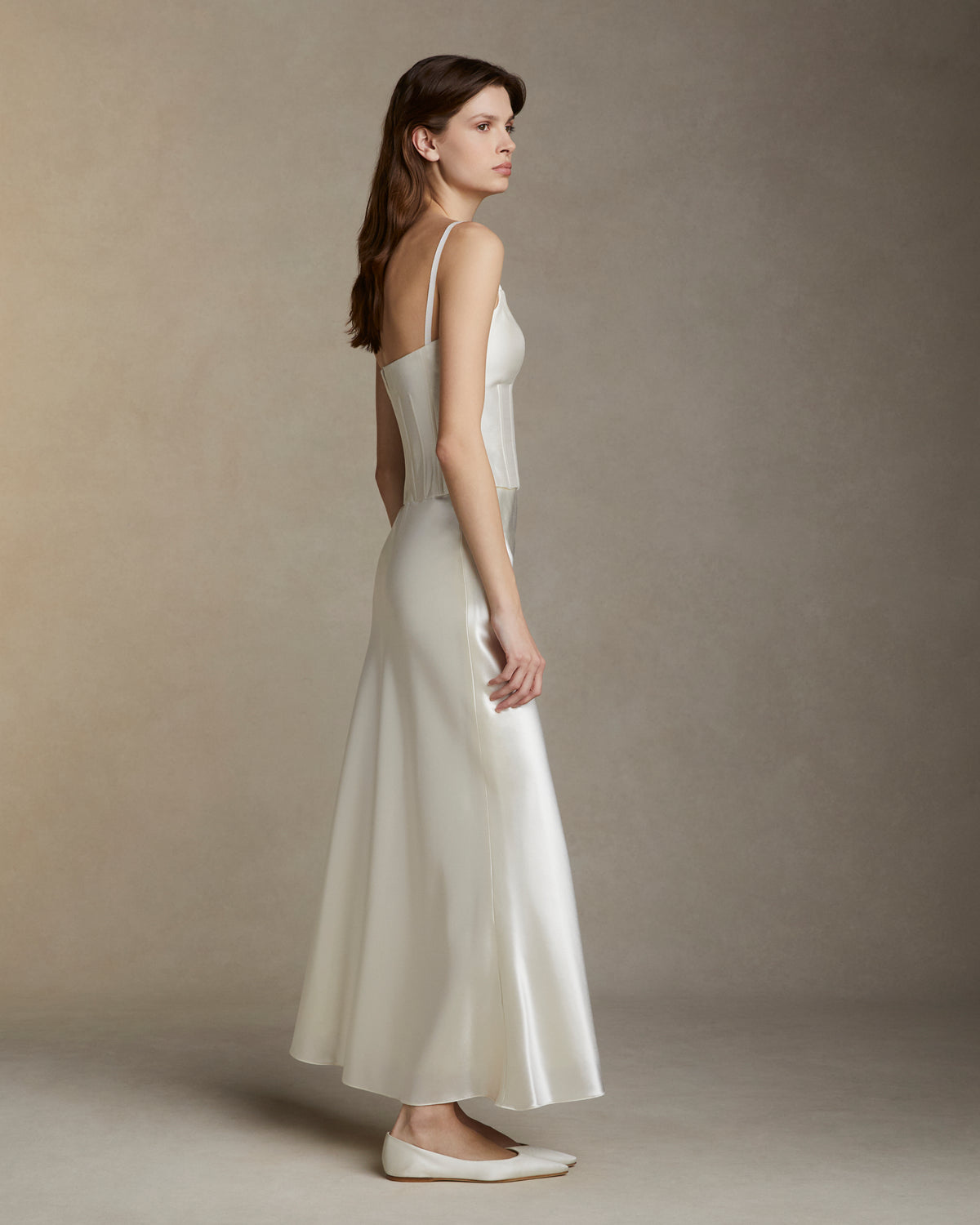 Bias cut silk wool skirt. Invisible side zip closure.Styled with Alice bustier