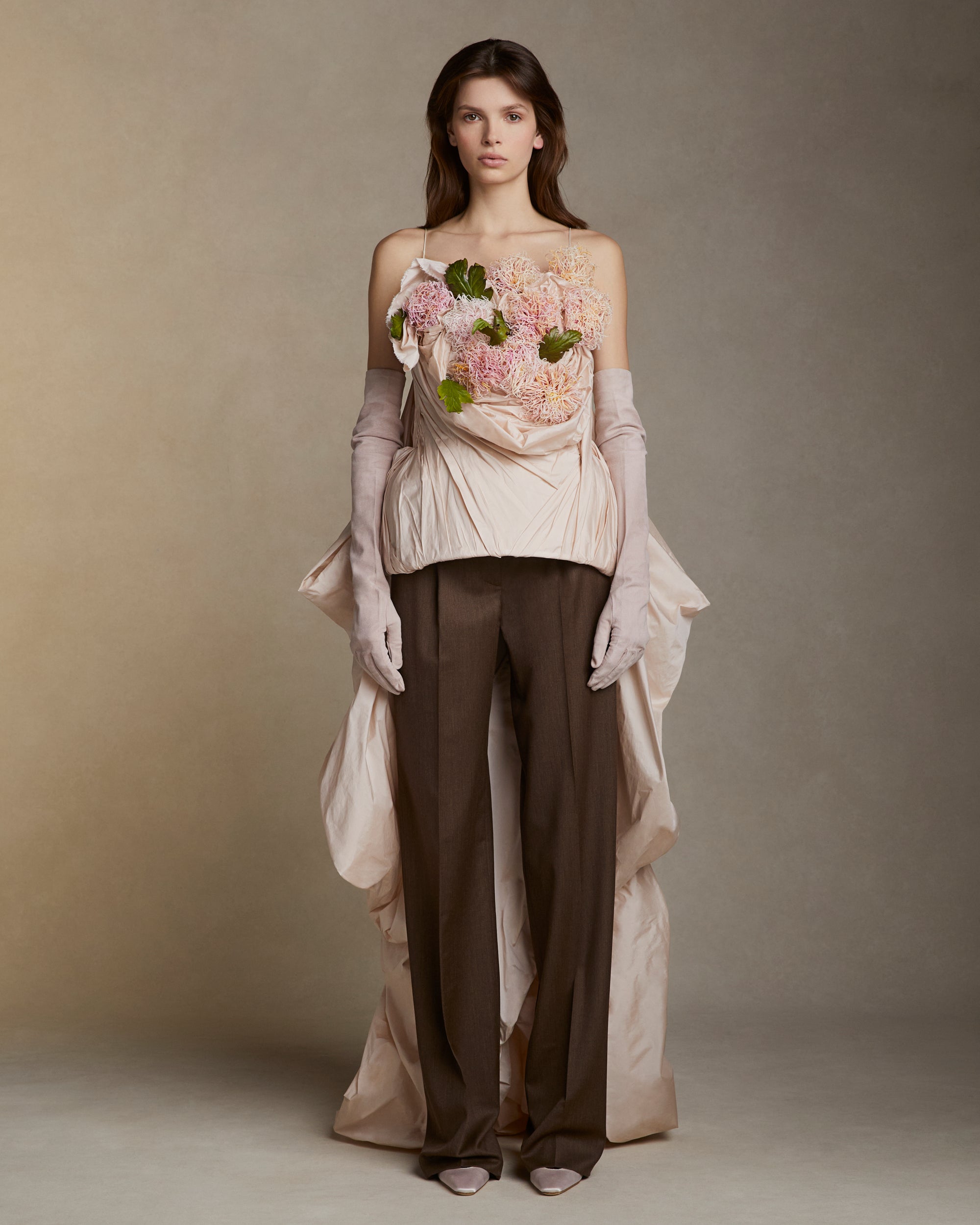 Featherweight silk taffeta bustier with hand crafted clay chrysanthemums and leaves. Layers of taffeta weave in and out of the clay flower bouquet, falling into a watteau at back. 