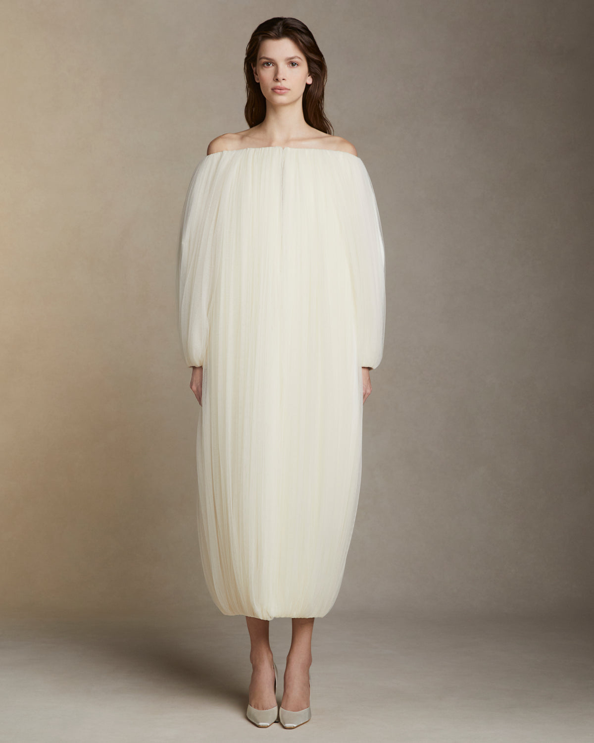Draped soft tulle off the shoulder cocoon coat. Hook and eye closure at center front.