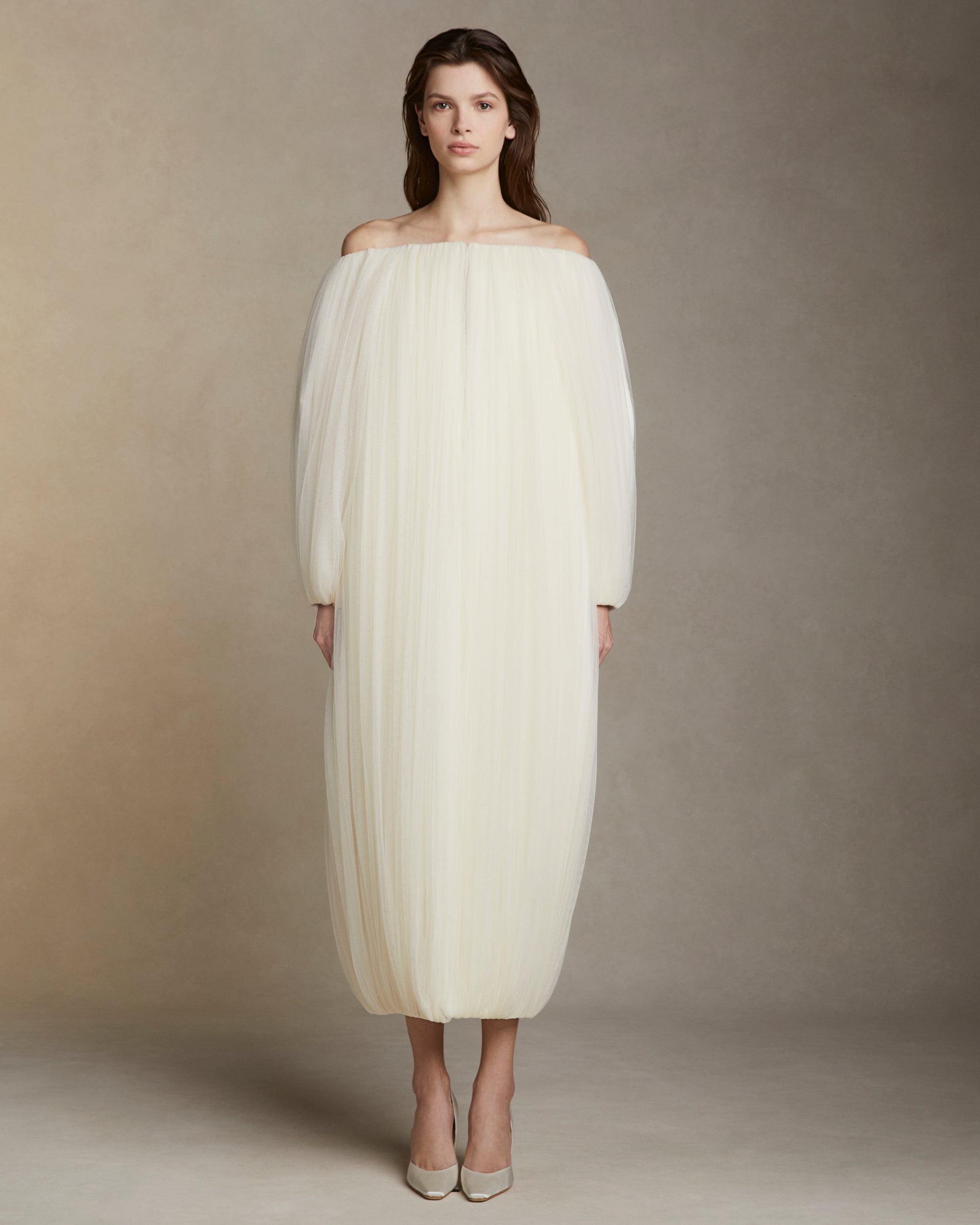 Draped soft tulle off the shoulder cocoon coat. Hook and eye closure at center front.