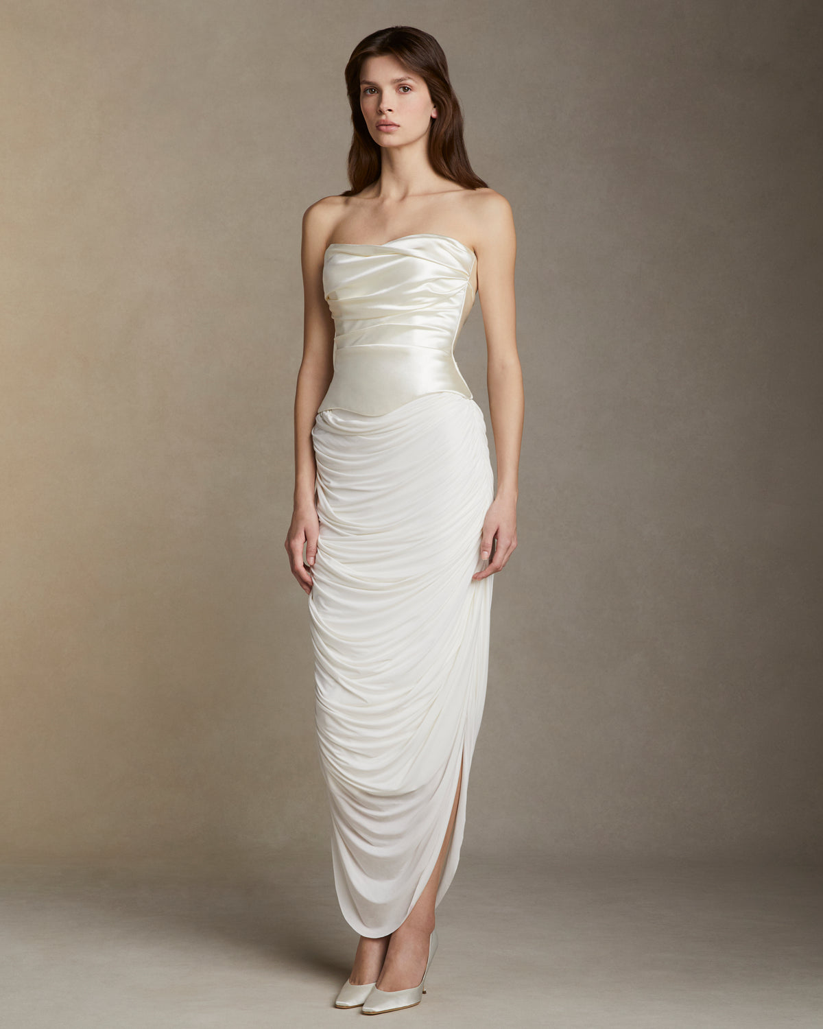 Fluid jersey skirt with cascading drape and side slits. Invisible zip closure at side.Styled with Demi﻿ bustier