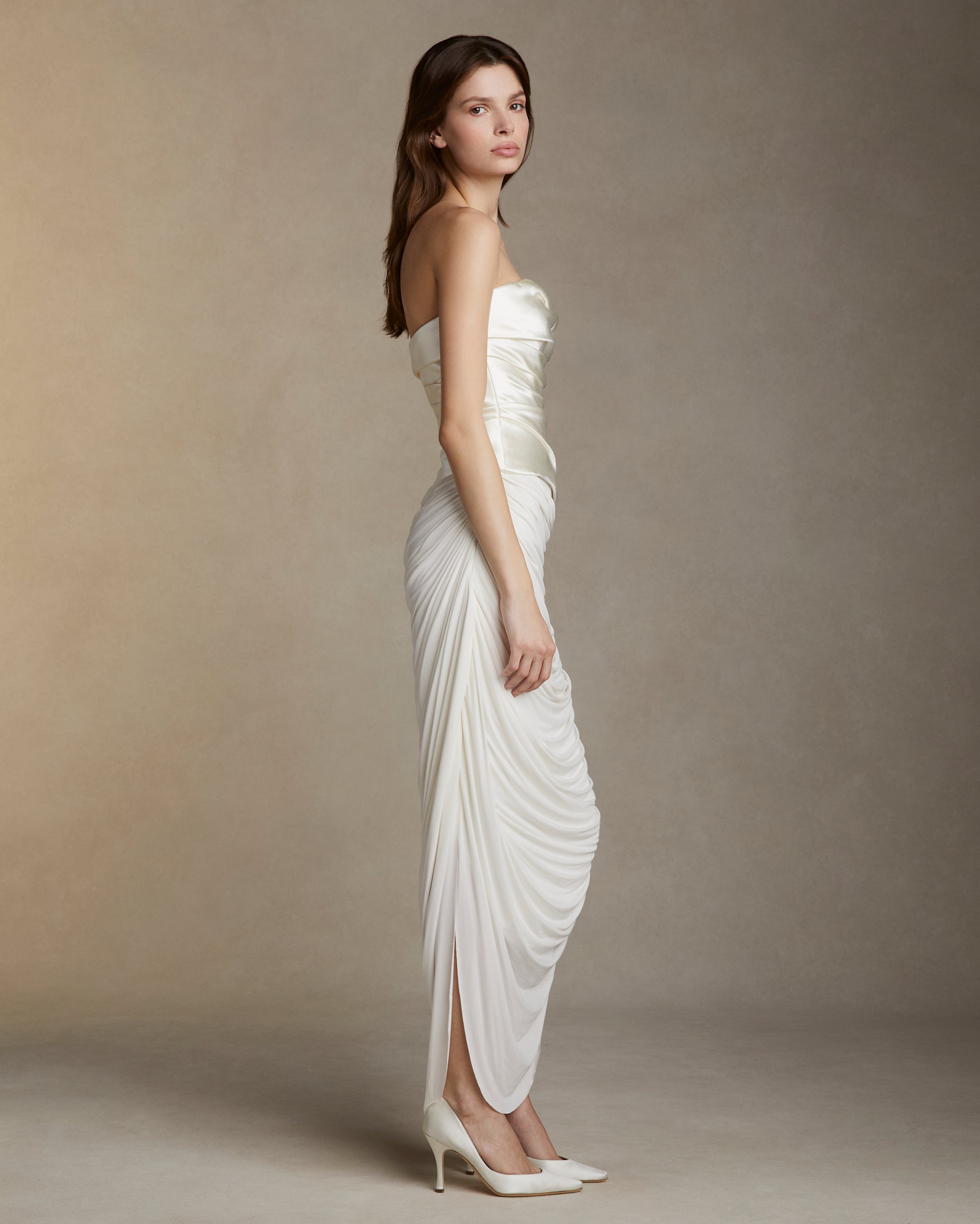 Silk wool strapless draped bodice with soft basque waistline. Invisible zip closure at center back.Styled with Vivienne skirt