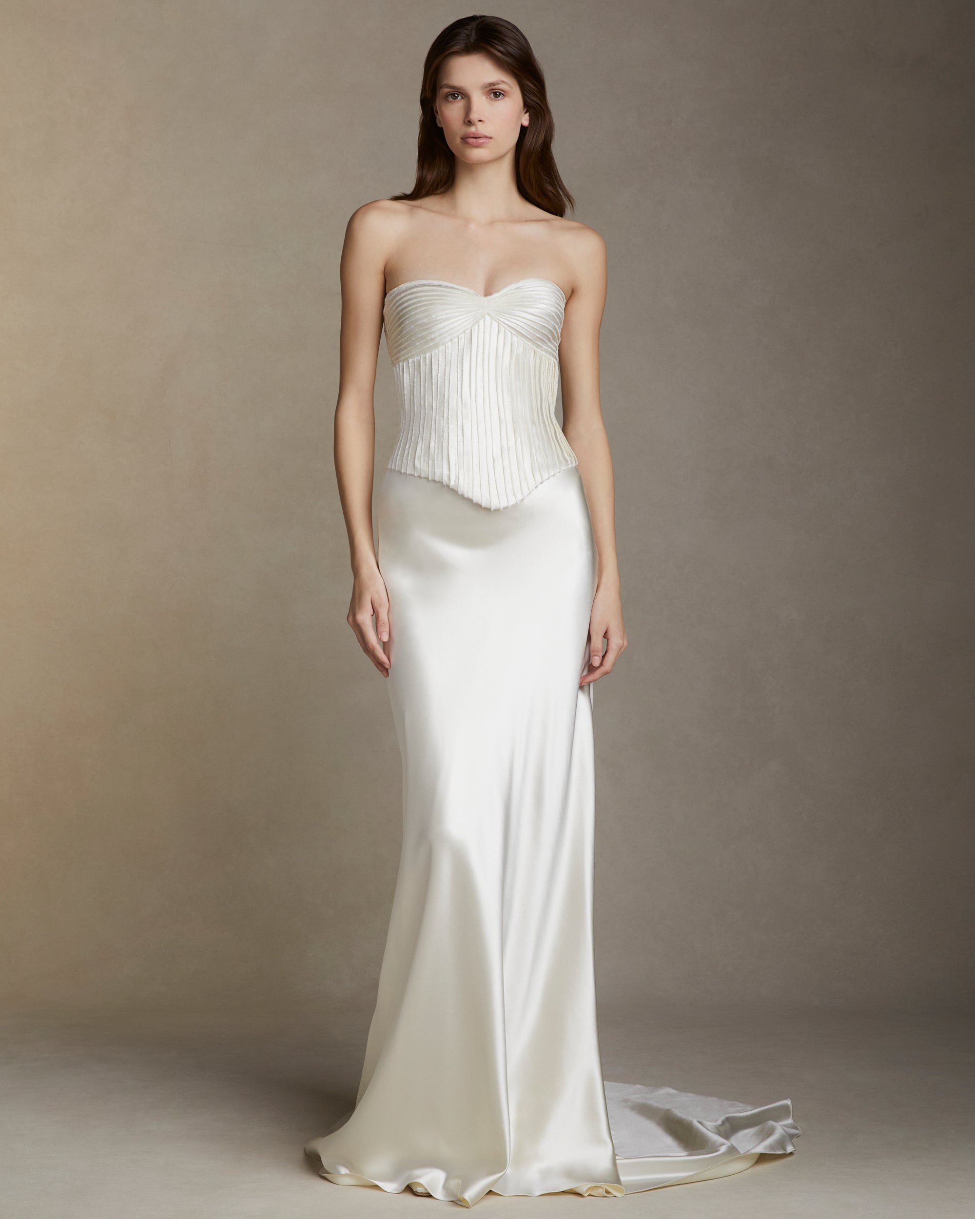 Strapless basque waist bodice decorated with hand cut and hand frayed bias silk wool strip fabric technique embroidery. Invisible zip closure at center back.Styled with Dree skirt &amp; Gia skirt