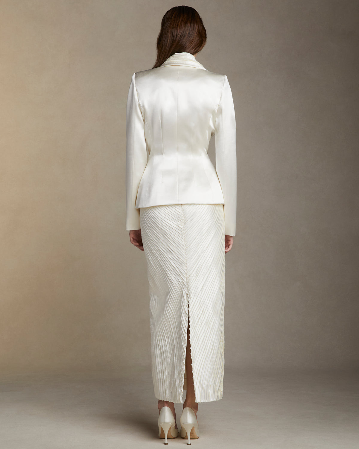 Silk wool jacket with hand cut and hand frayed bias silk wool strip lapel. Tailored nipped waist and structured hip shape. Welt  pocket at bust and single link closure at center front.Styled with Gia skirt