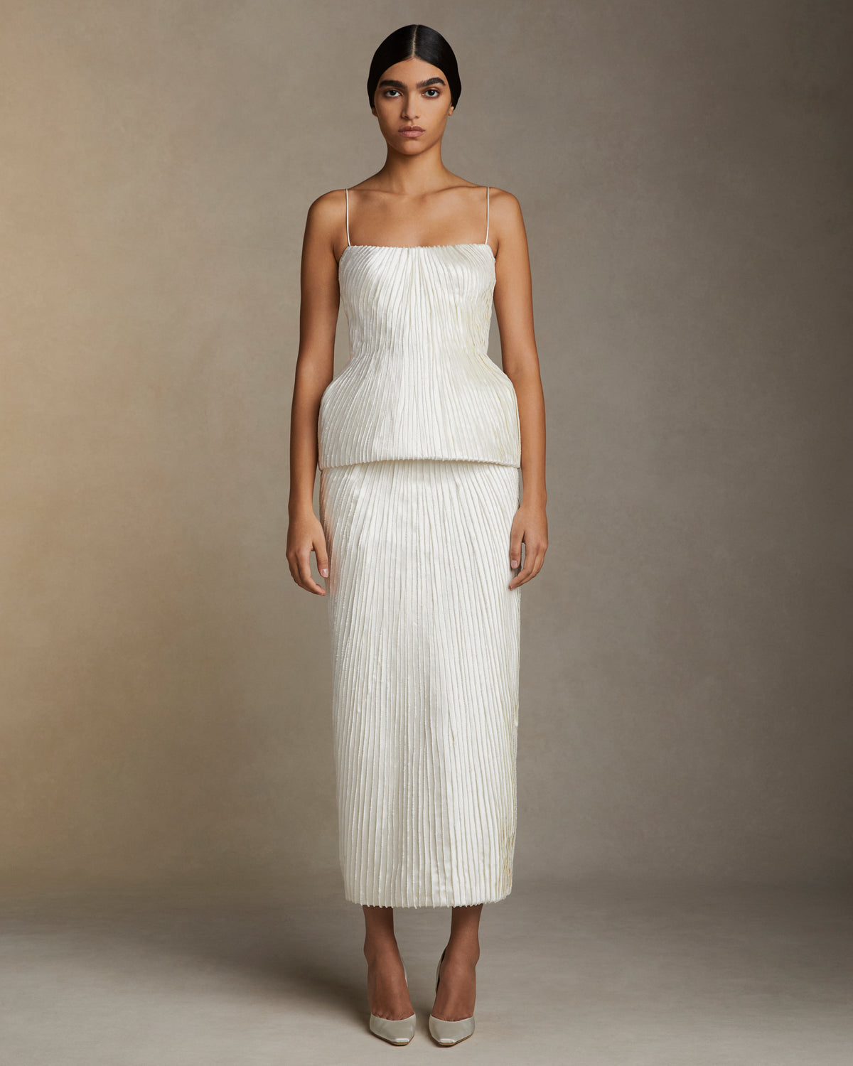 Straight skirt decorated with hand cut and hand frayed bias silk wool strip fabric technique embroidery. Invisible zipper closure at center back.Styled with Gemma top & Ella bustier
