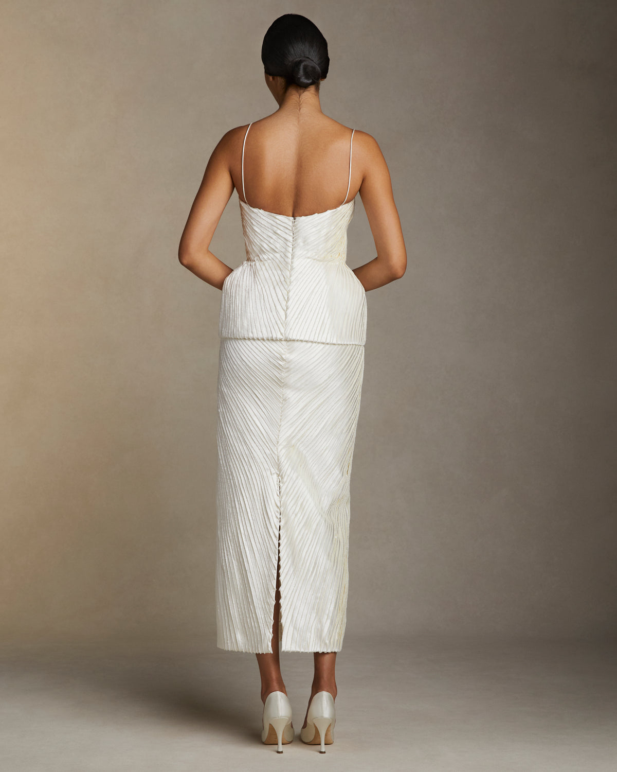 Straight skirt decorated with hand cut and hand frayed bias silk wool strip fabric technique embroidery. Invisible zipper closure at center back.Styled with Gemma top & Ella bustier