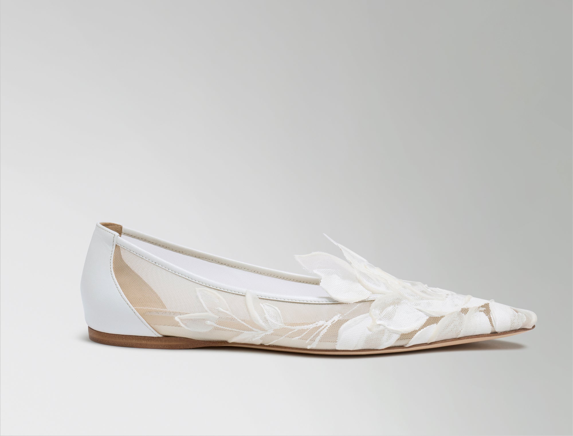 Mesh ballerina flat crafted in Italy with hand painted ivory floral detail. Elongated round toe, tonal piped leather top edge, and covered heel.