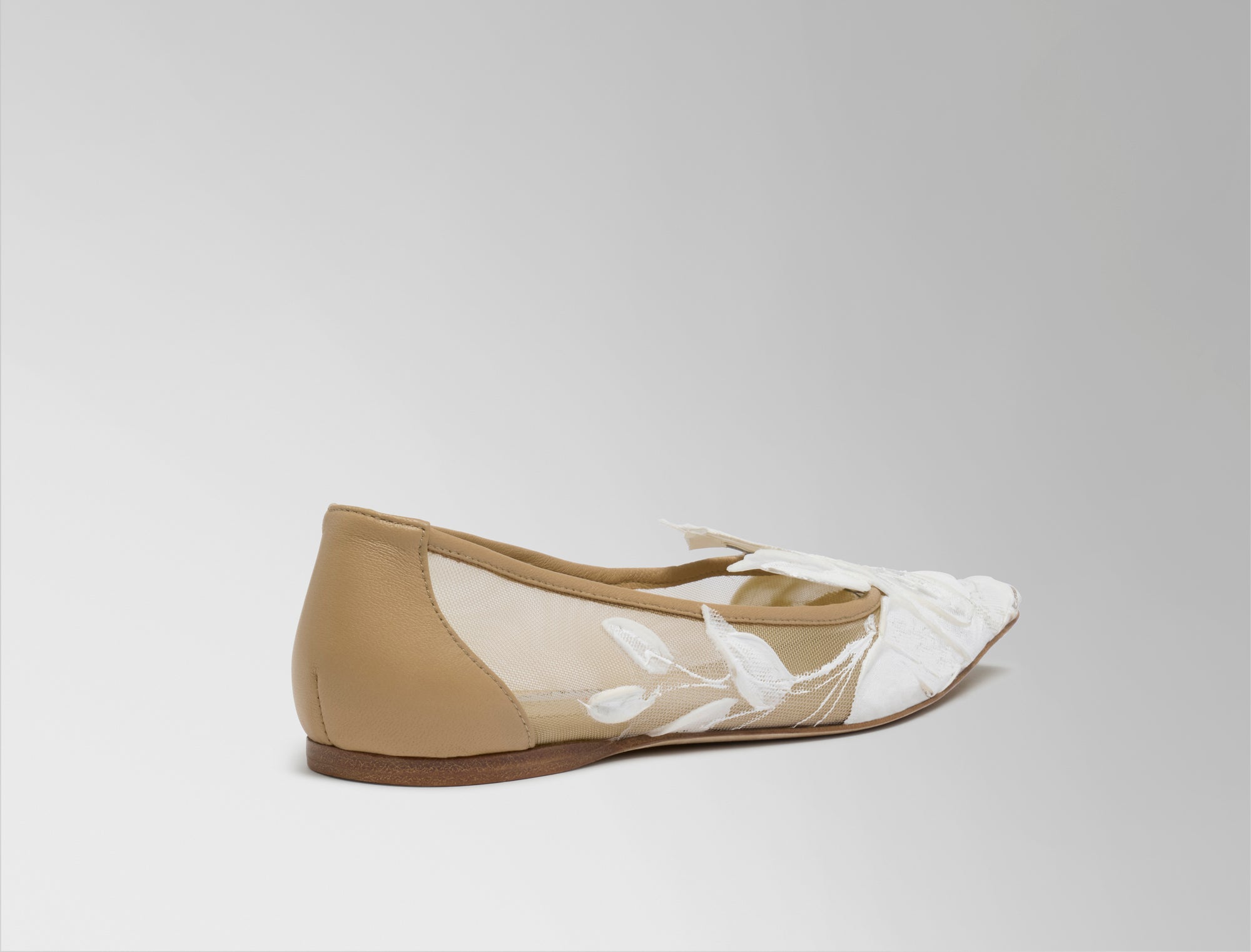 Mesh ballerina flat crafted in Italy with hand painted ivory floral detail. Elongated round toe, tonal piped leather top edge, and covered heel.