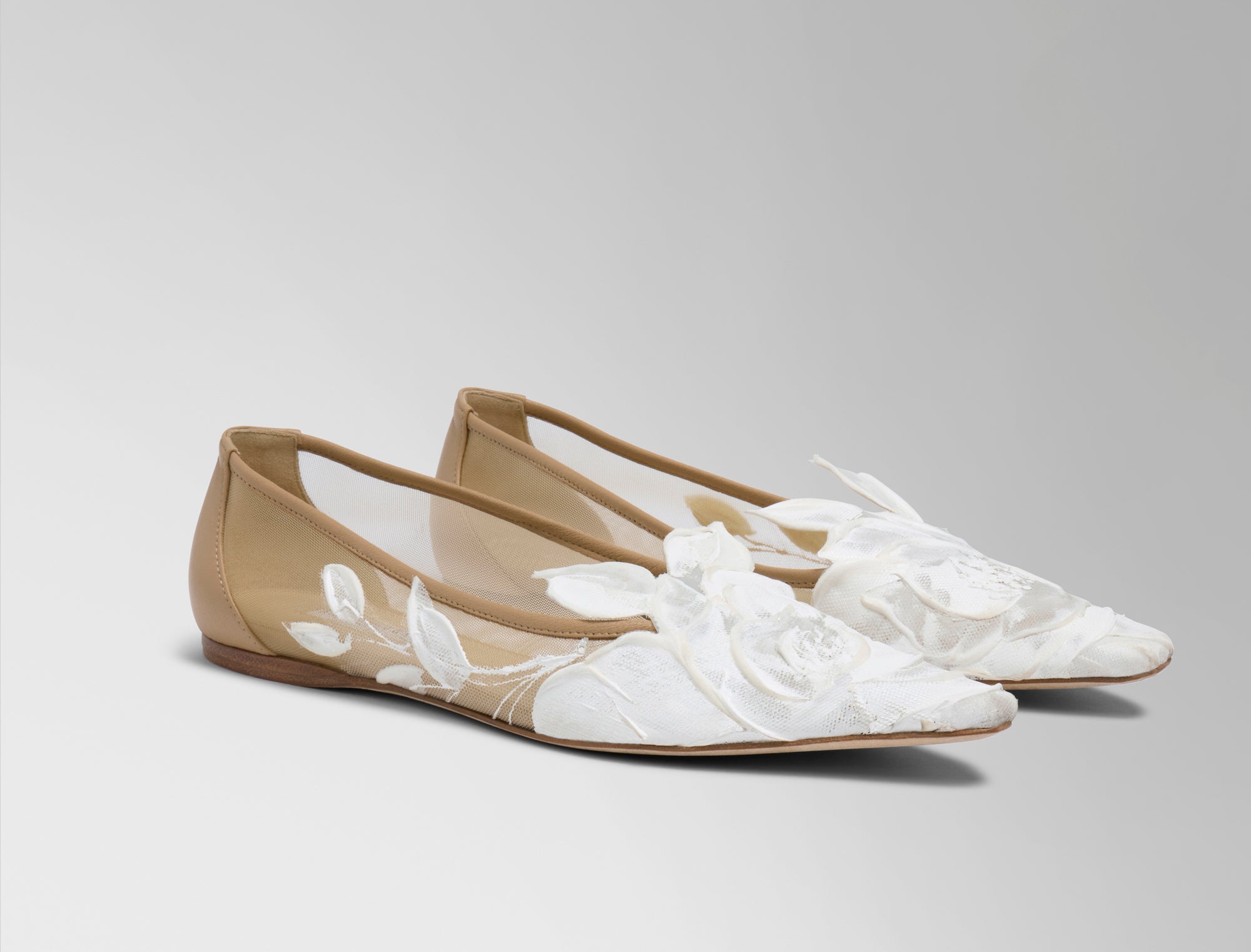 Mesh ballerina flat crafted in Italy with hand painted ivory floral detail. Elongated round toe, tonal piped leather top edge, and covered heel.