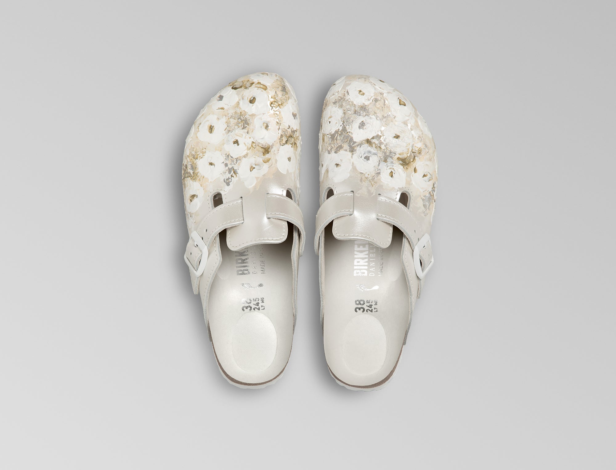 The iconic Boston is updated in an ivory pearlized finish leather with powder coated ivory buckle. Bespoke hand painted florals decorate the leather upper. Hand crafted in Germany and hand painted in France. Exclusively available through Danielle Frankel Studio.- Upper: Delicate satin upper, piped trim edge detail for premium tuxedo like finish- Footbed: Anatomical shaped BIRKENSTOCK cork latex Footbed lined with premium Nappa Leather- Sole: EVA die cut outsole with a custom design, blending classic BIRKENSTOCK bone pattern with delicate leaf inspired detailing 
