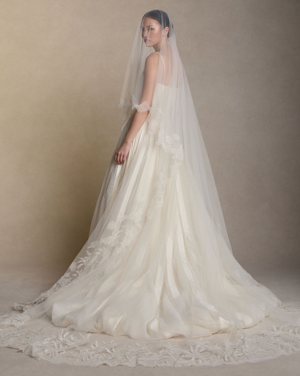Soft tulle veil gathered into comb with hand cut Chantilly lace border detail and Chantilly lace degradé appliques.110” from comb to hem with 28