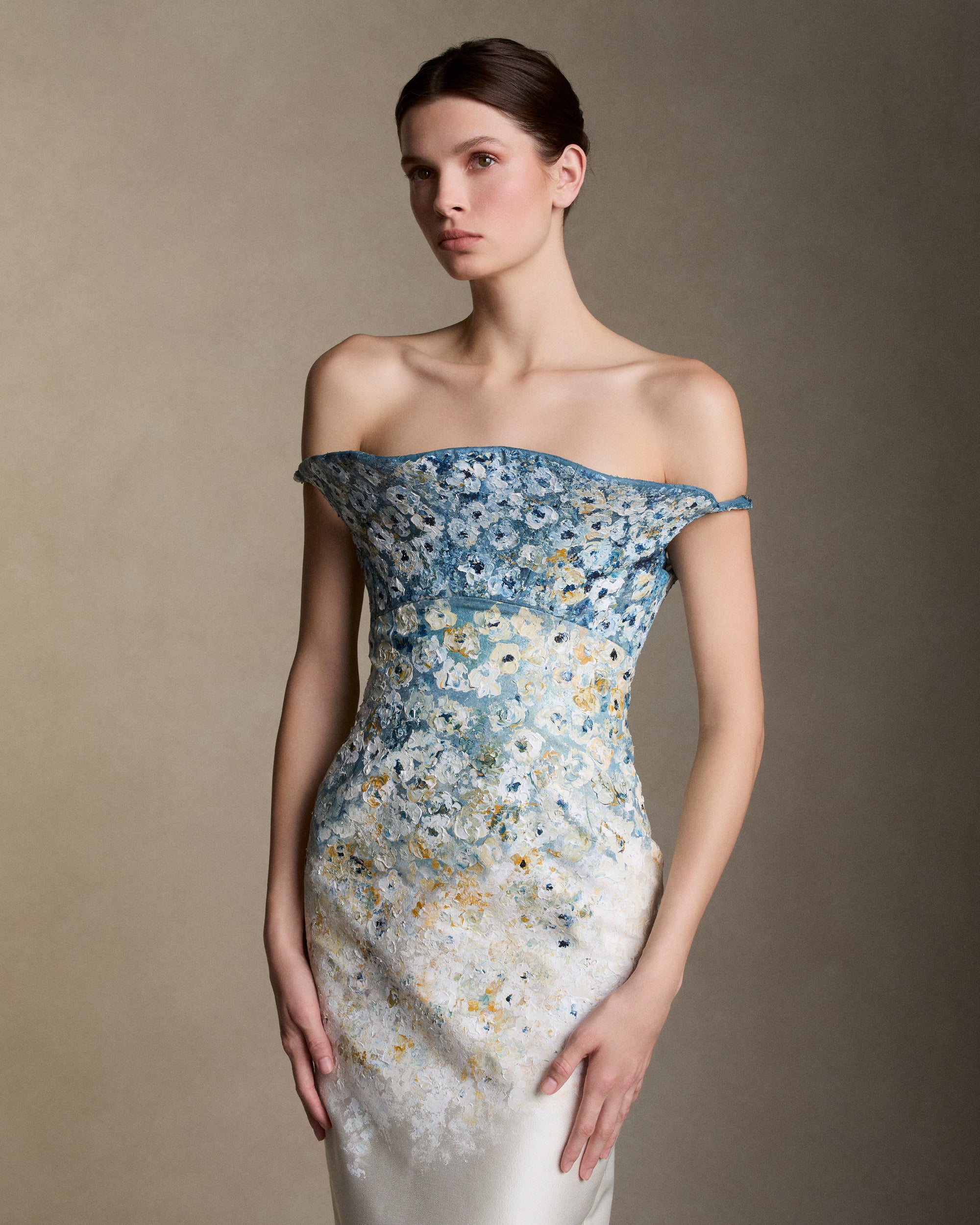 Floral degrade hand painted silk wool twill column gown with sculptural bustier and exaggerated flared neckline. Boned internal bustier, internal grosgrain belt and invisible zip closure at center back.