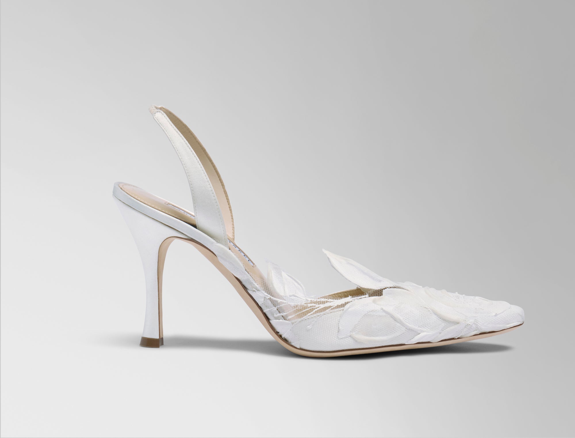 Classic slingback crafted in Italy of ivory satin with hand painted ivory floral detail. Elongated round toe and 90mm heel.