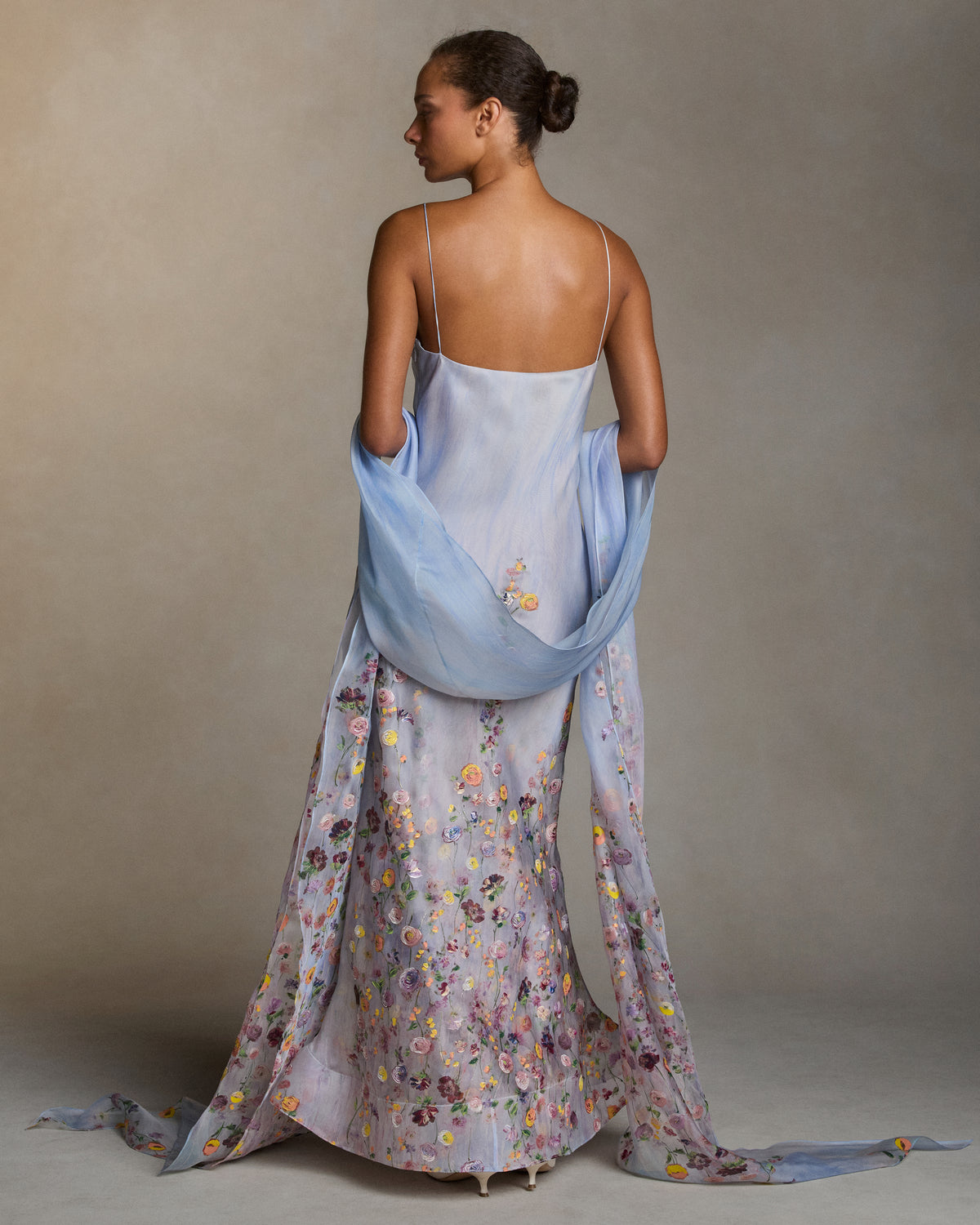 Silk Organza stole with a printed watercolor effect and hand-painted florals climb and fade softly up the body. 18" wide with peaked ends