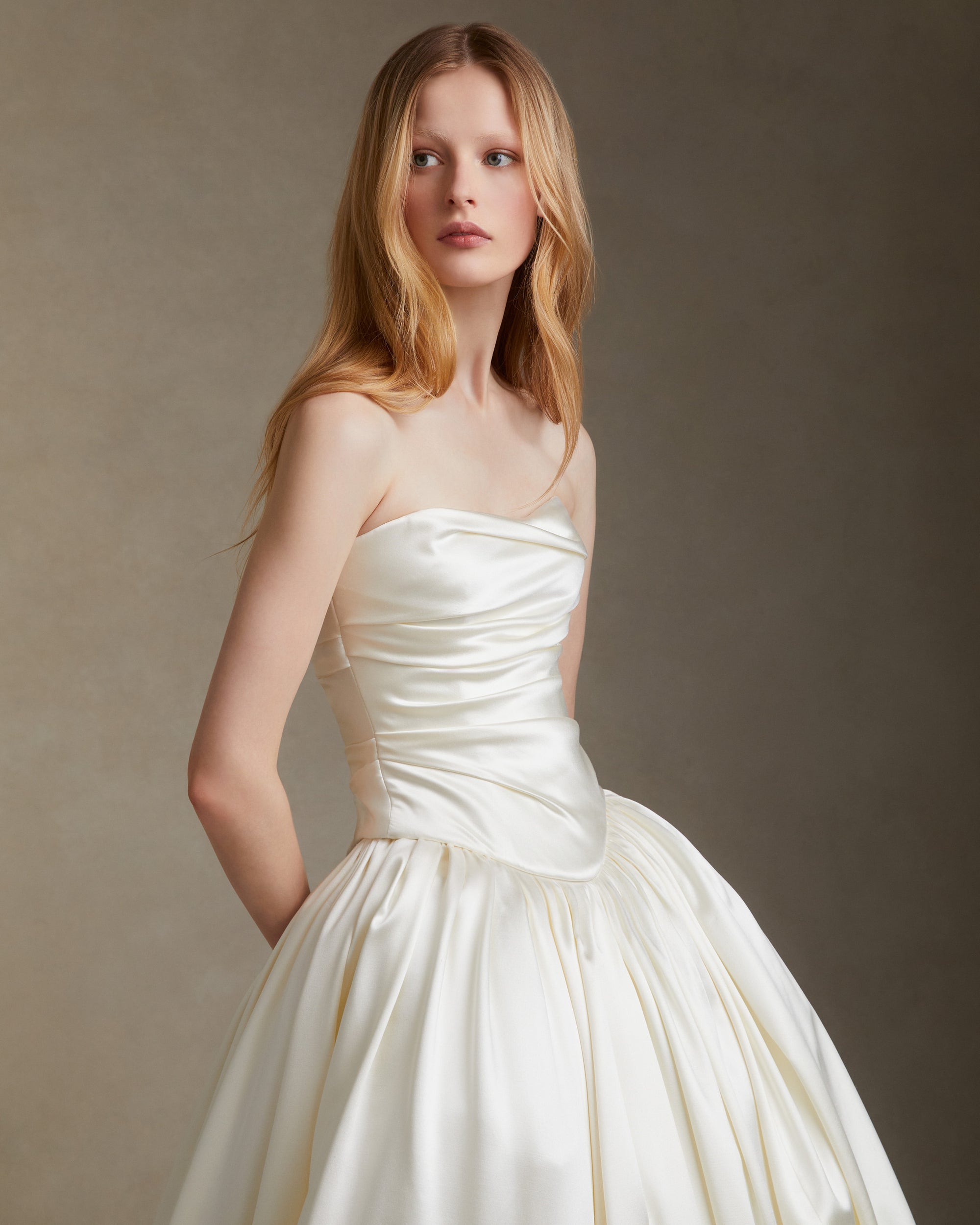 Dramatic silk wool ball skirt with basque waist yoke and bubble hem detail. Invisible zip closure at center back.Styled with Demi bustier
