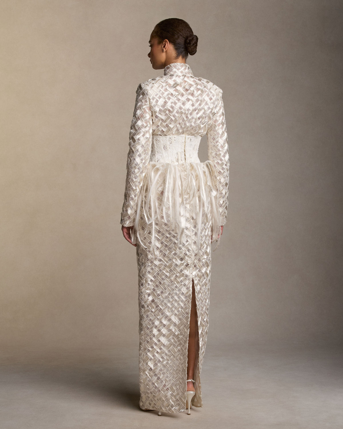 Jacket cut from pewter-toned woven silk and metal embroidery. Bias-cut ribbons are layered with hand-frayed organza and finished with a center front hook-and-eye closure.Styled with Dita skirt and Vienna stomacher