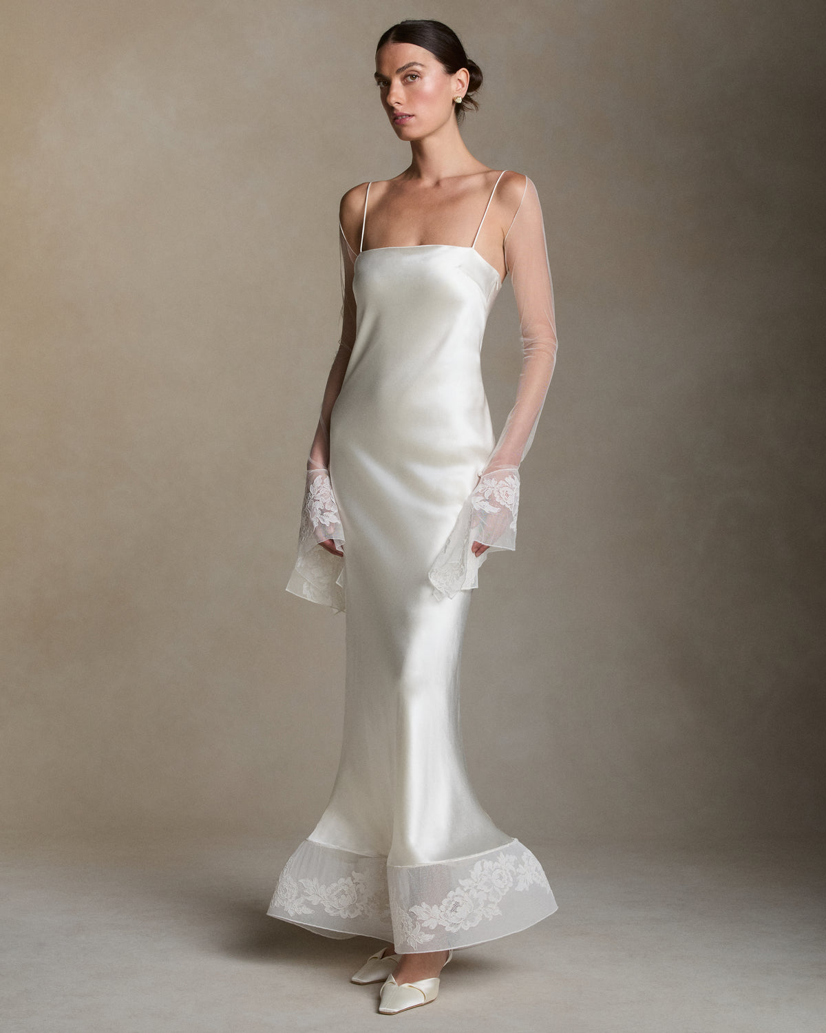 Soft tulle sleeves with bell cuff detail in Lyon lace. Silk spaghetti tie detail at center back neckline.