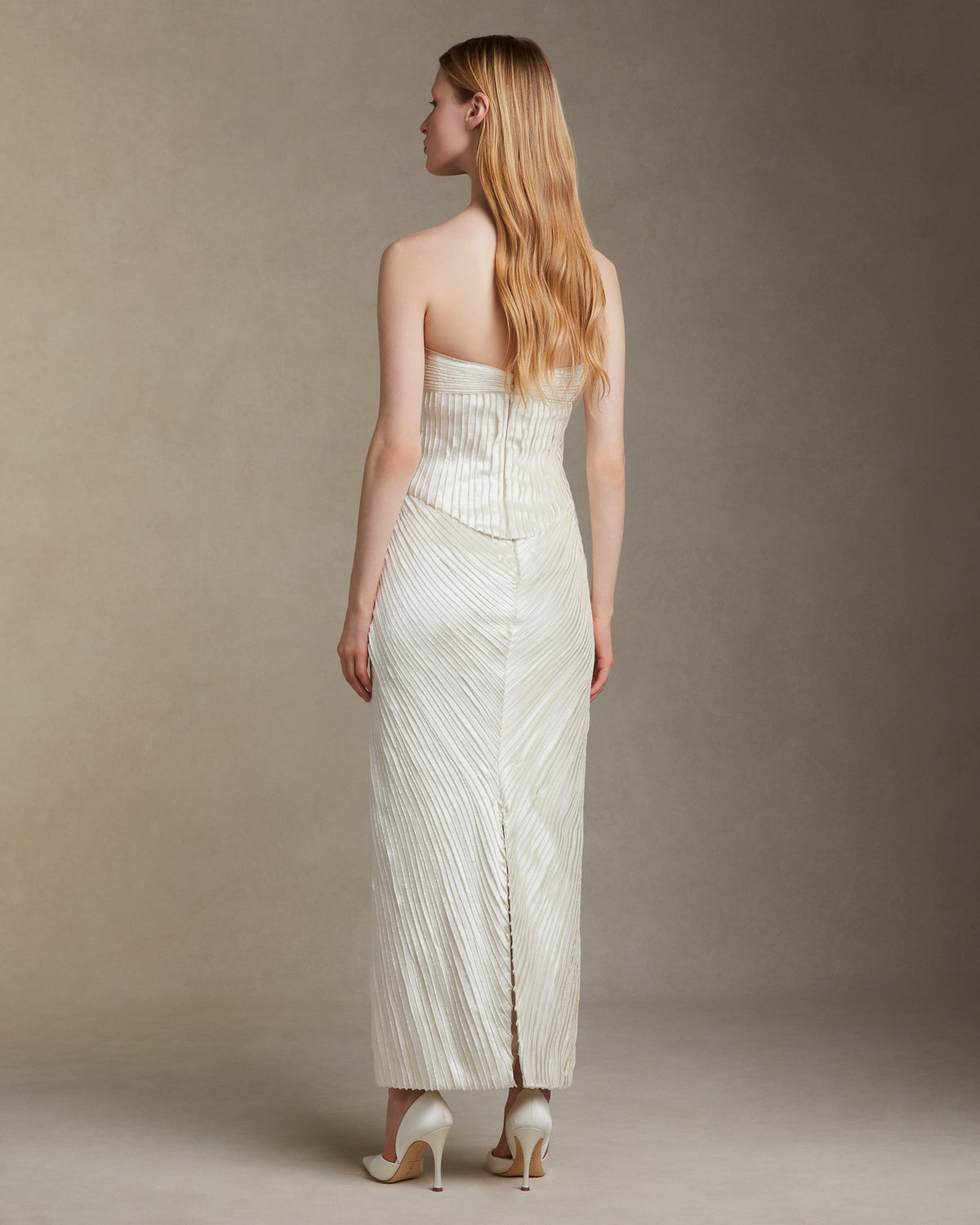 Straight skirt decorated with hand cut and hand frayed bias silk wool strip fabric technique embroidery. Invisible zipper closure at center back.Styled with Gemma top & Ella bustier