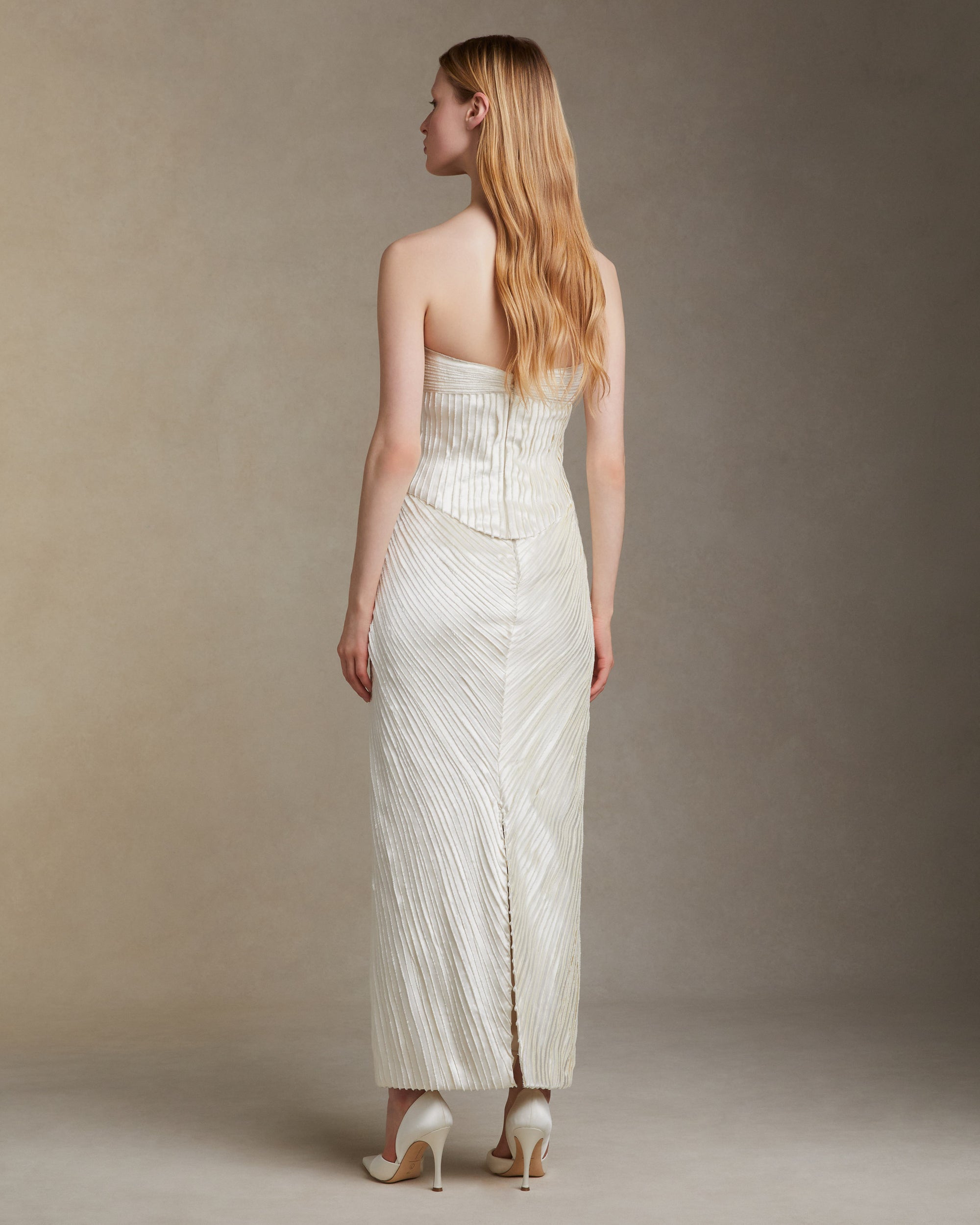 Straight skirt decorated with hand cut and hand frayed bias silk wool strip fabric technique embroidery. Invisible zipper closure at center back.Styled with Gemma top &amp; Ella bustier