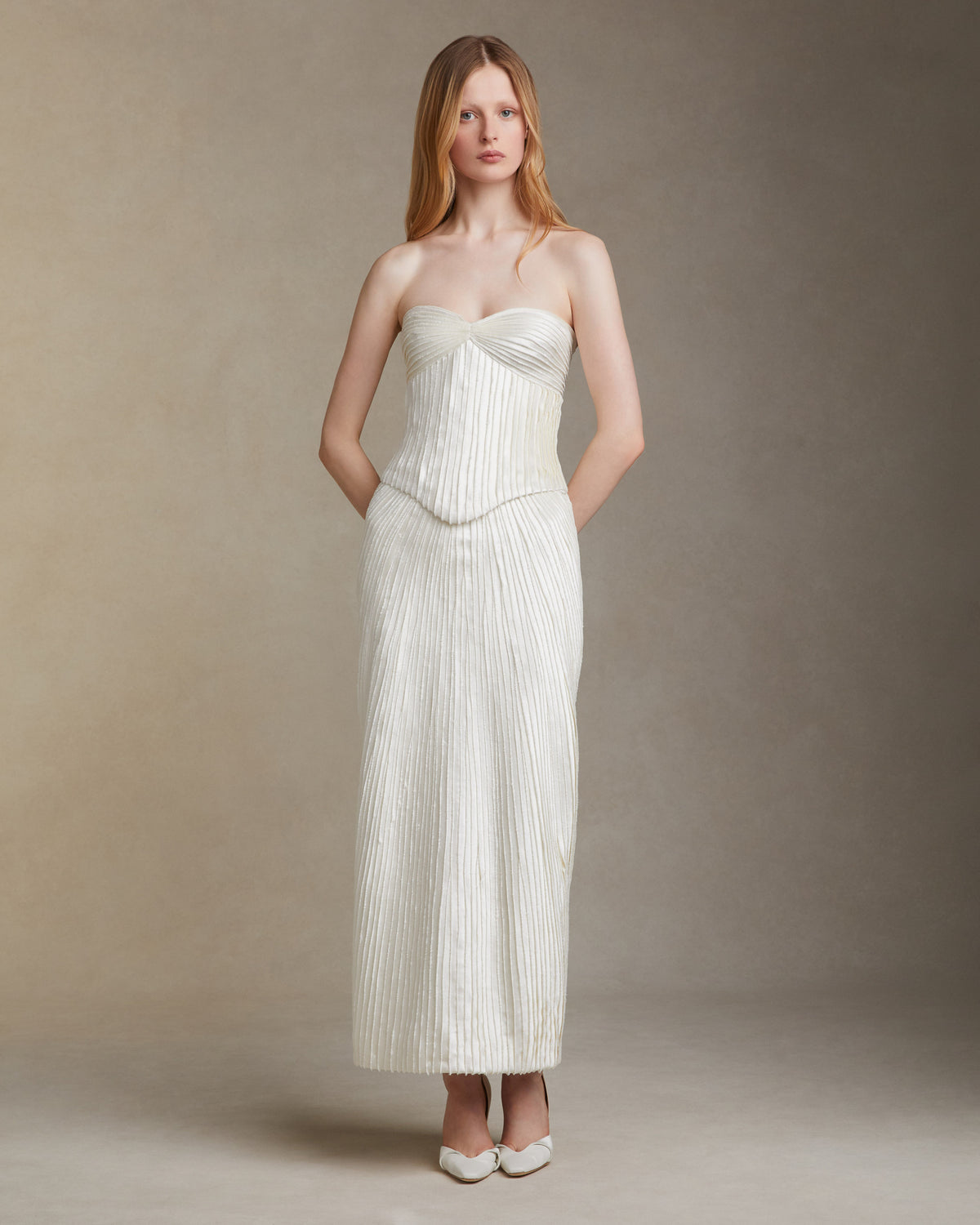 Straight skirt decorated with hand cut and hand frayed bias silk wool strip fabric technique embroidery. Invisible zipper closure at center back.Styled with Gemma top & Ella bustier