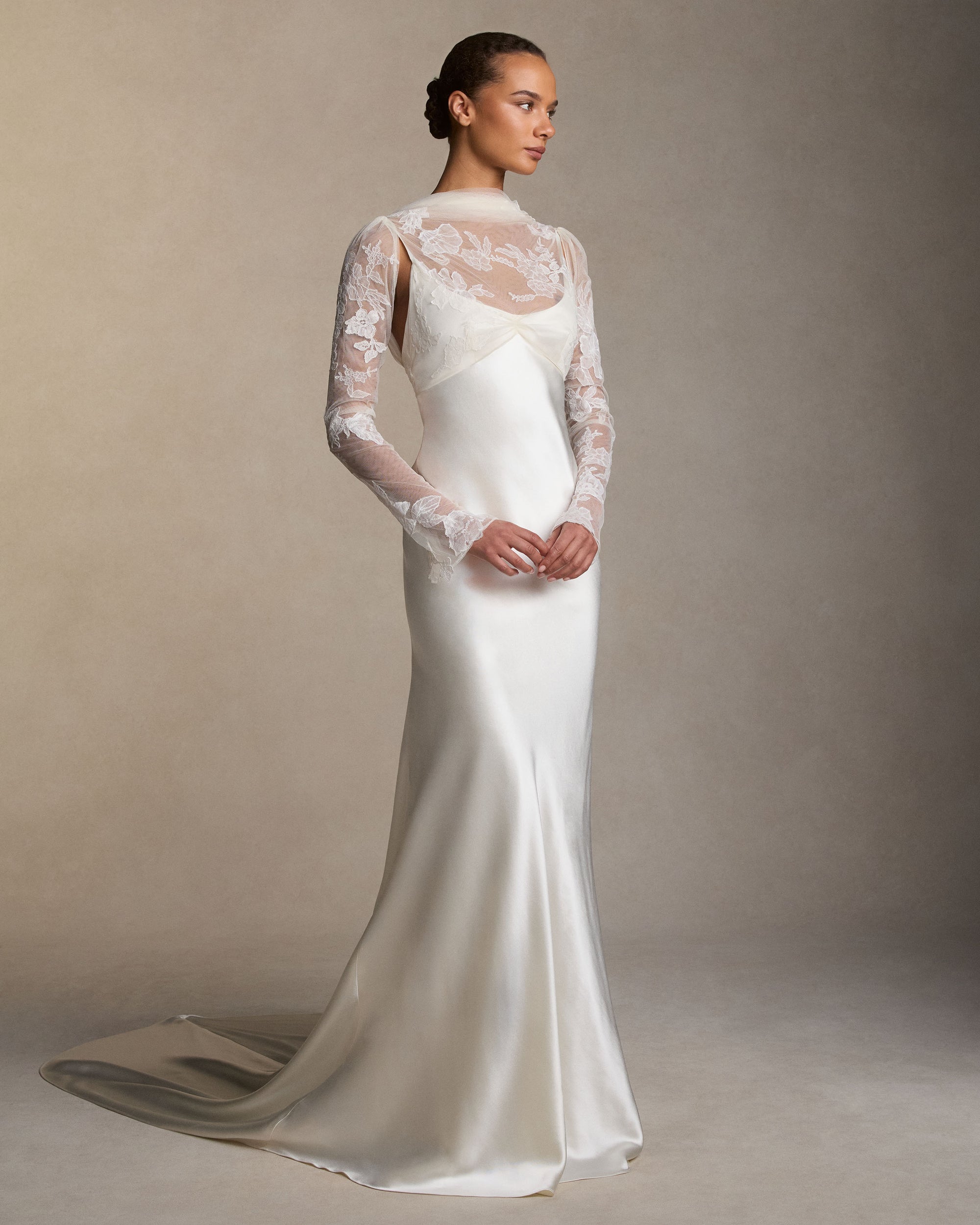 Silk wool slip gown with long sleeve tulle overlay bodice decorated in hand cut corded and chantilly lace applique. Removable sleeves and invisible zip closure at center back. Available without sleeves for $5990