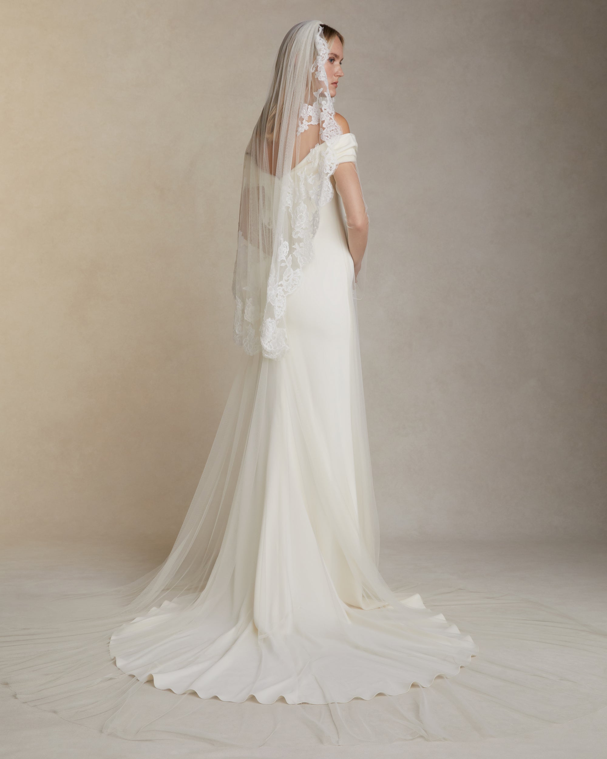 Soft tulle veil with hand cut &amp; appliquéd corded and Chantilly lace border. Tulle is gathered into comb and extends 45" from comb to hem