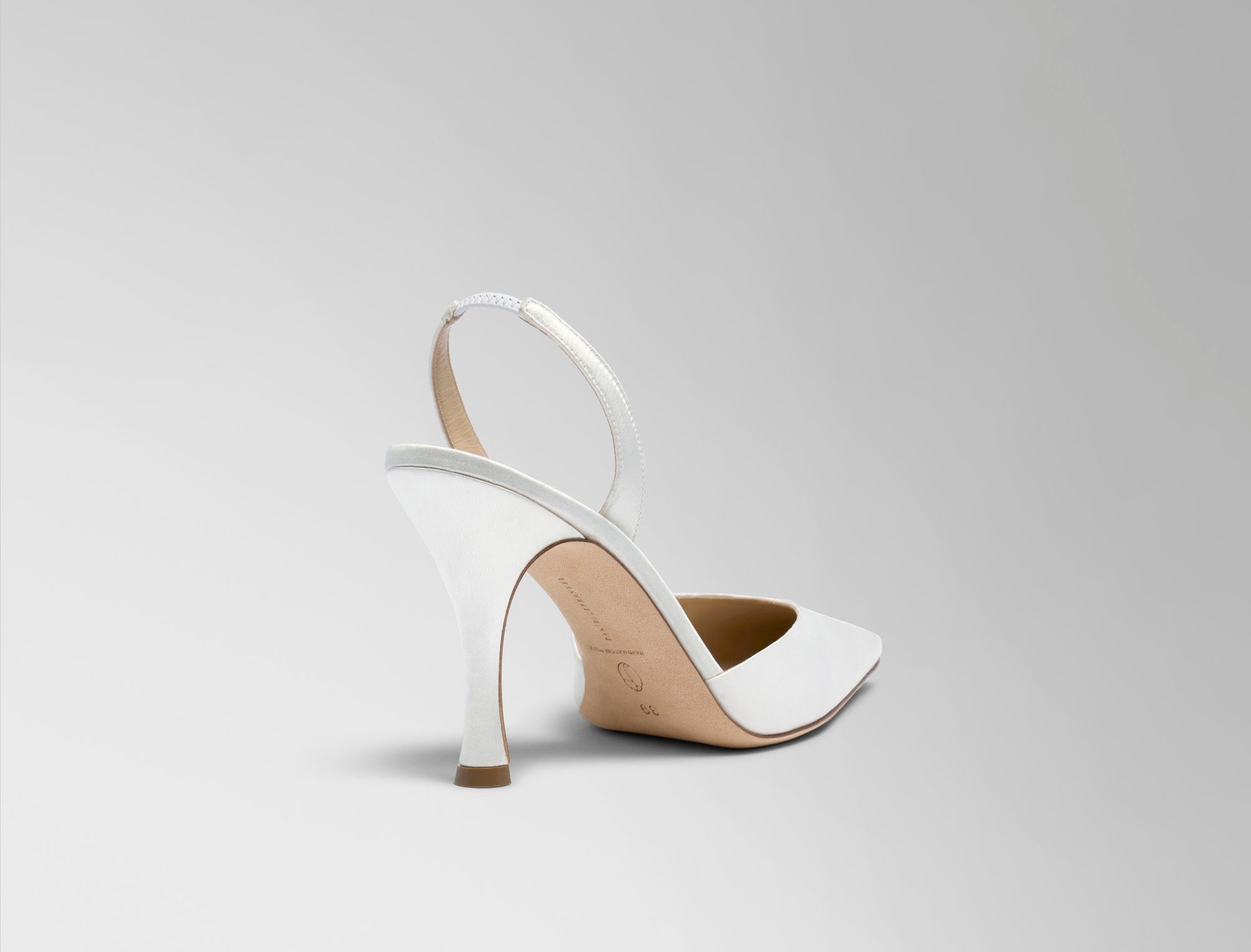 Classic slingback crafted in Italy of ivory satin. Elongated round toe and 90mm heel.