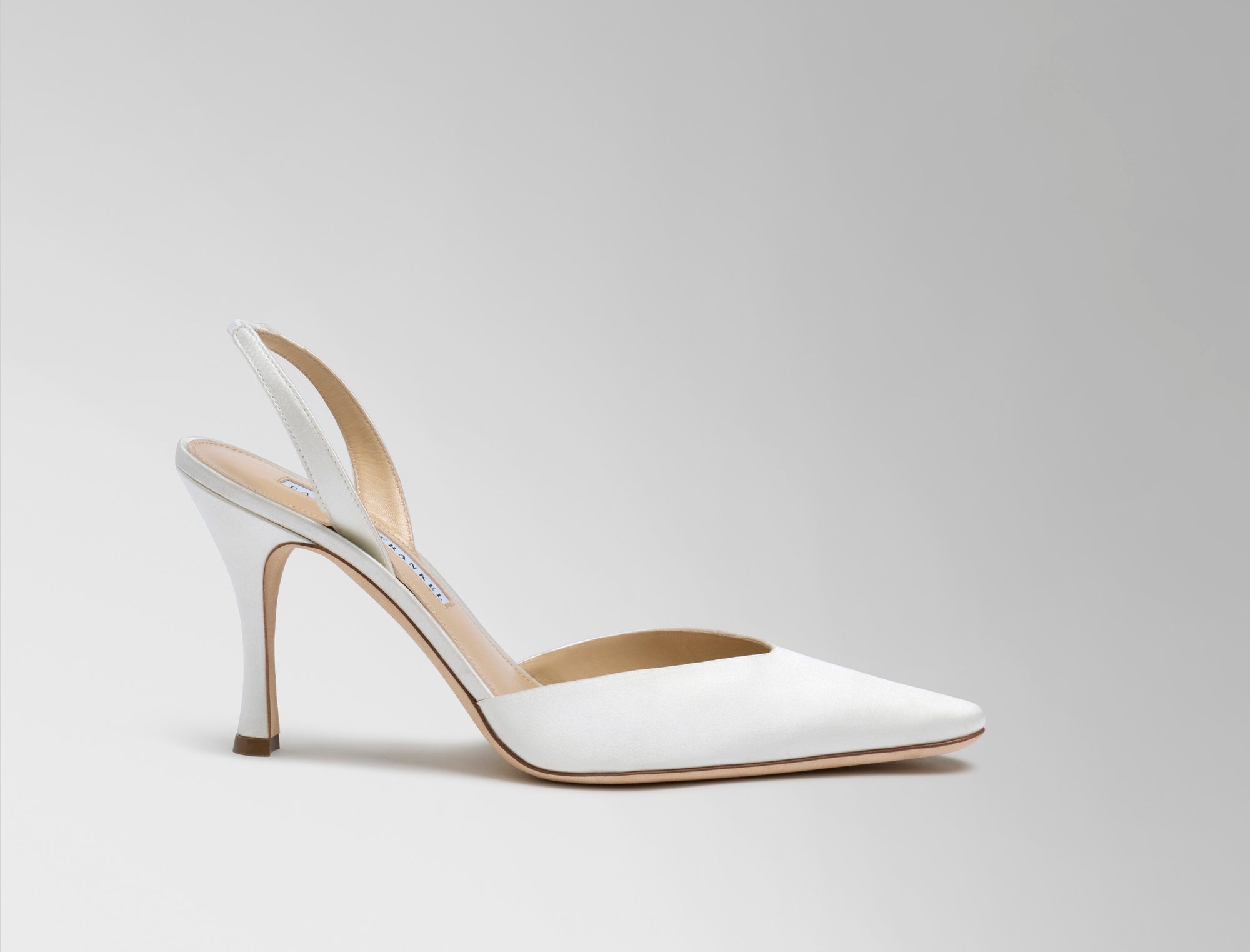 Classic slingback crafted in Italy of ivory satin. Elongated round toe and 90mm heel.