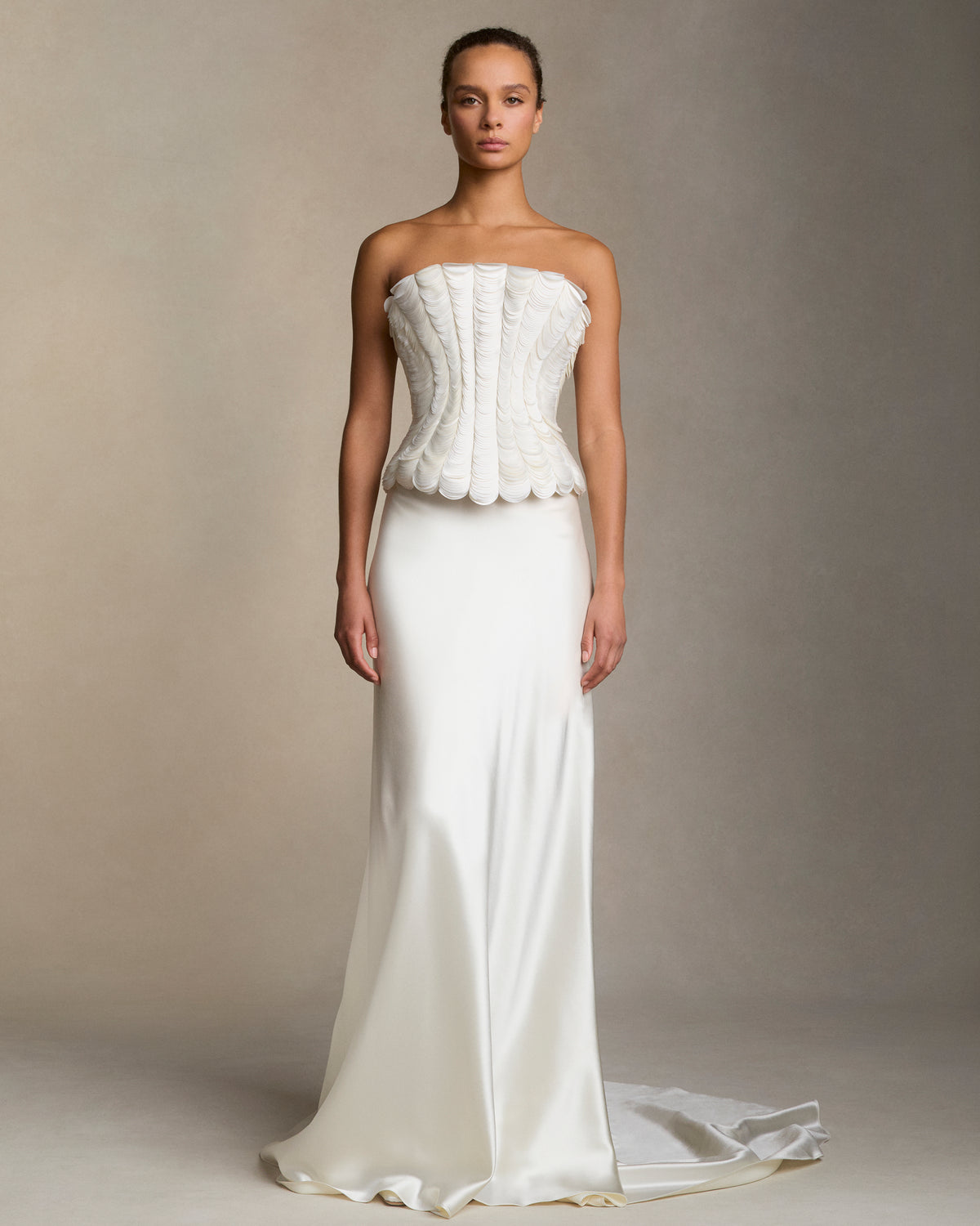 Structured bustier with thousands of layered satin petals shaping the flared neckline silhouette. Boned internal bustier, internal grosgrain belt and invisible zip closure at center back.Styled with Dree skirt & Tess skirt