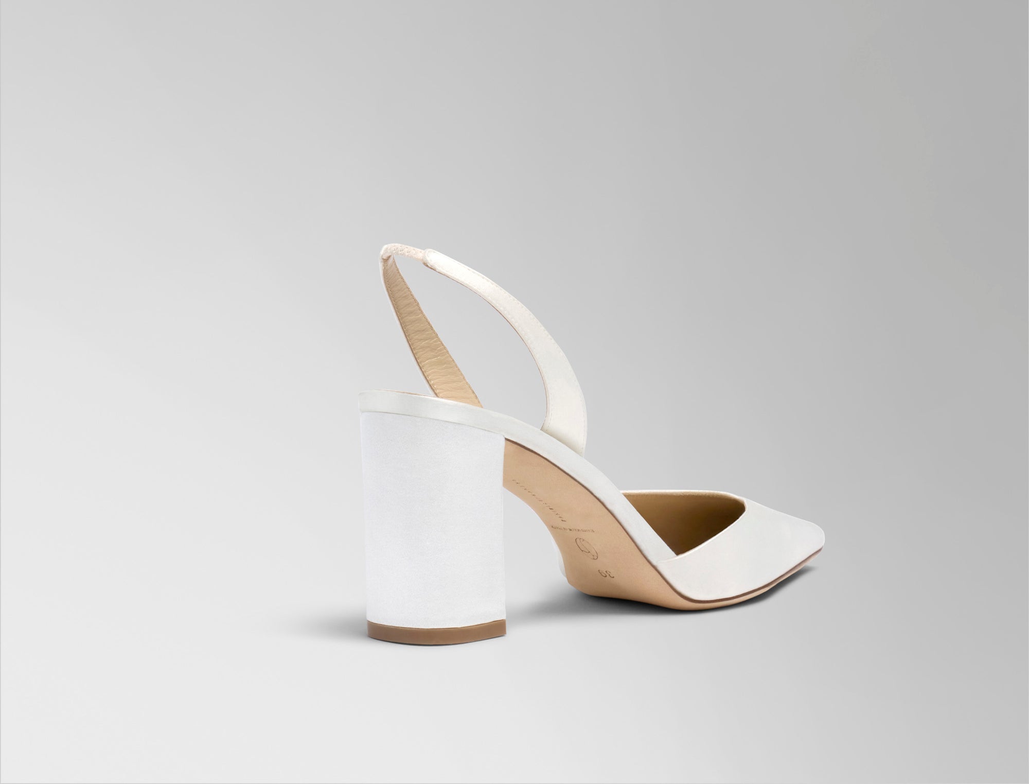 Classic rounded square toe slingback crafted in Italy of ivory satin. 75mm block heel.
