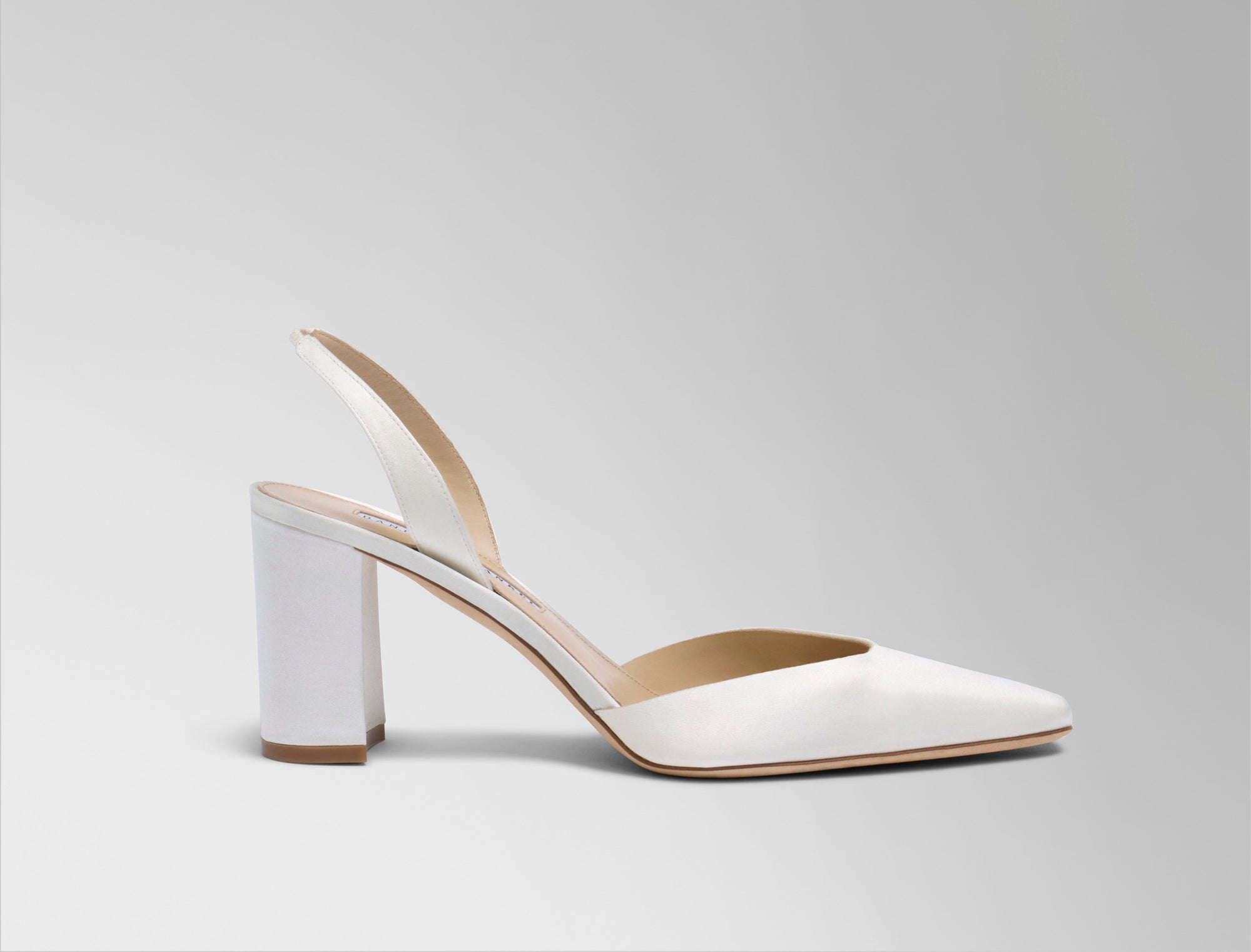 Classic rounded square toe slingback crafted in Italy of ivory satin. 75mm block heel.