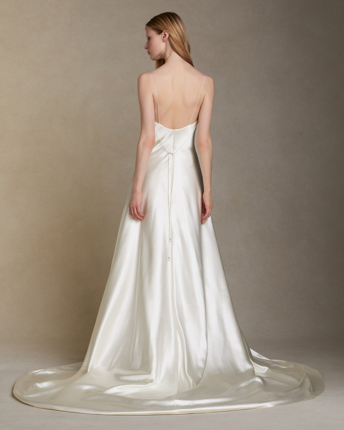 Silk wool A line bias gown with asymmetric dipped neckline. Internal bustier. Invisible zip closure at center back.