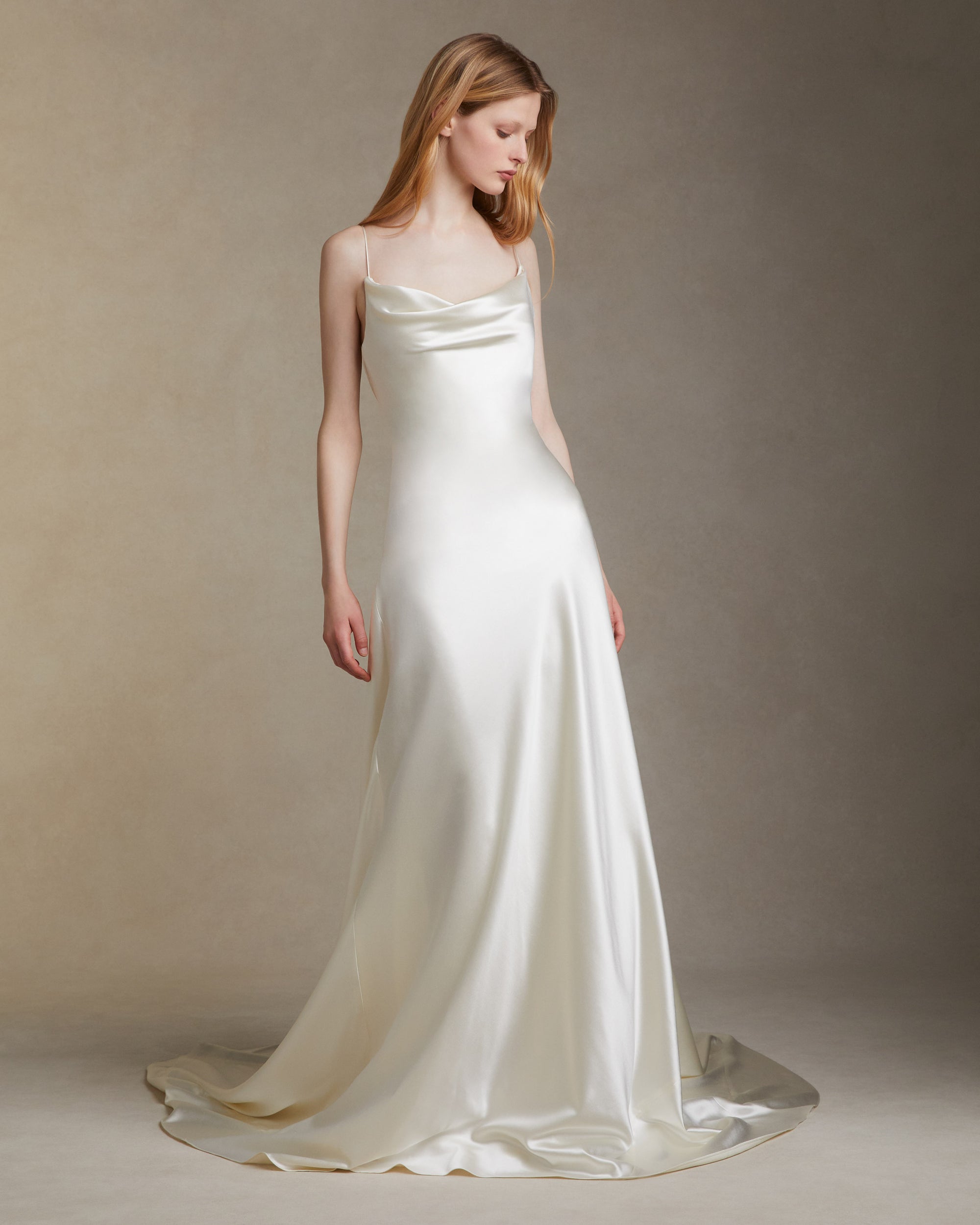 Silk wool A line bias gown with asymmetric dipped neckline. Internal bustier. Invisible zip closure at center back.