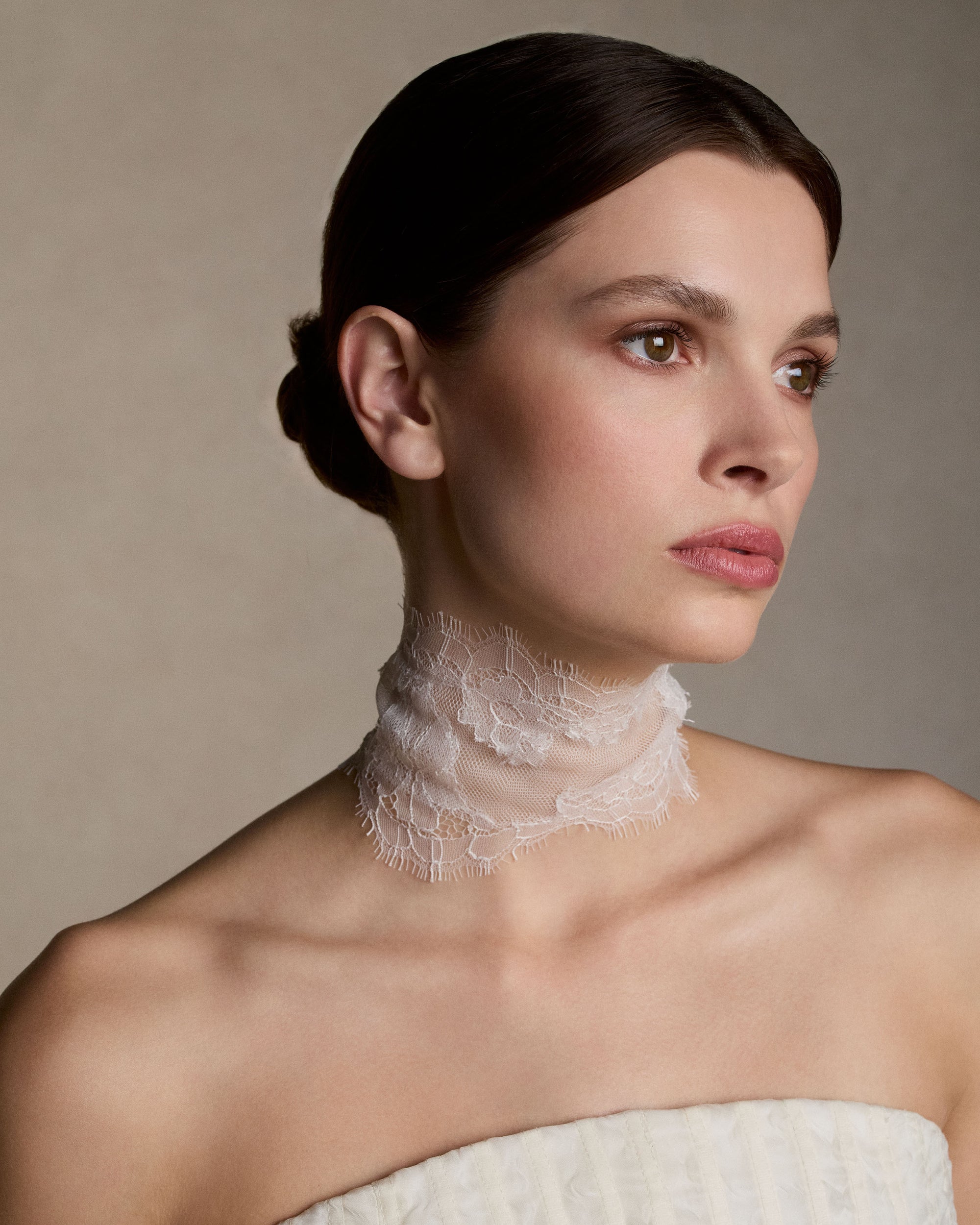 Soft tulle and chantilly lace collar with hand cut appliques and scalloped border detail. Covered button and elastic loop closure. 