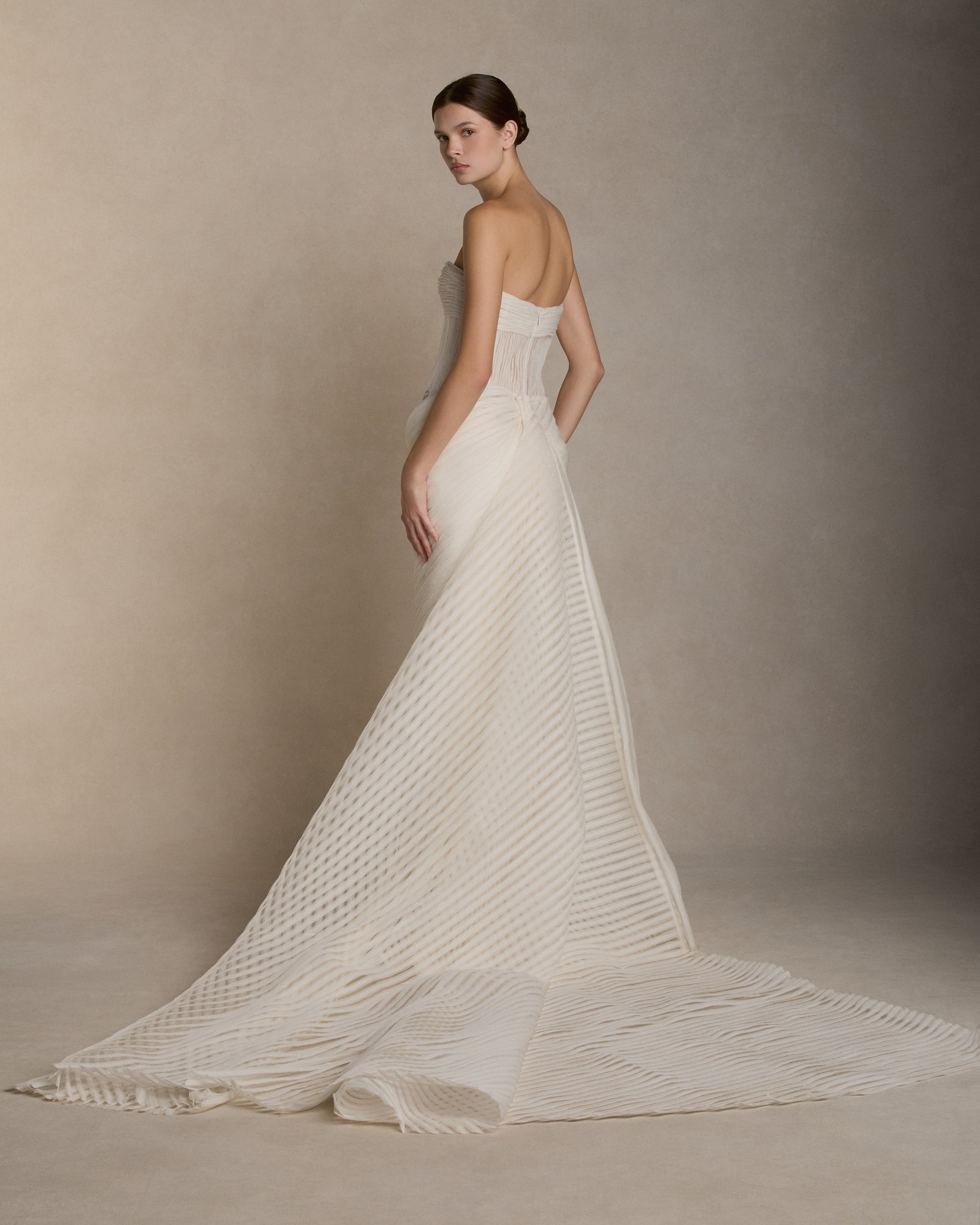 Crinkle organza and chiffon bias strip gown with hand painted iris florals at waist. Ivory crinkle organza organza bias strip embroidery decorates the nude bobinette bodice and transparent chiffon bias strip horsehair embroidery cascades over a silk wool twill column skirt. Invisible zip closure at center back.