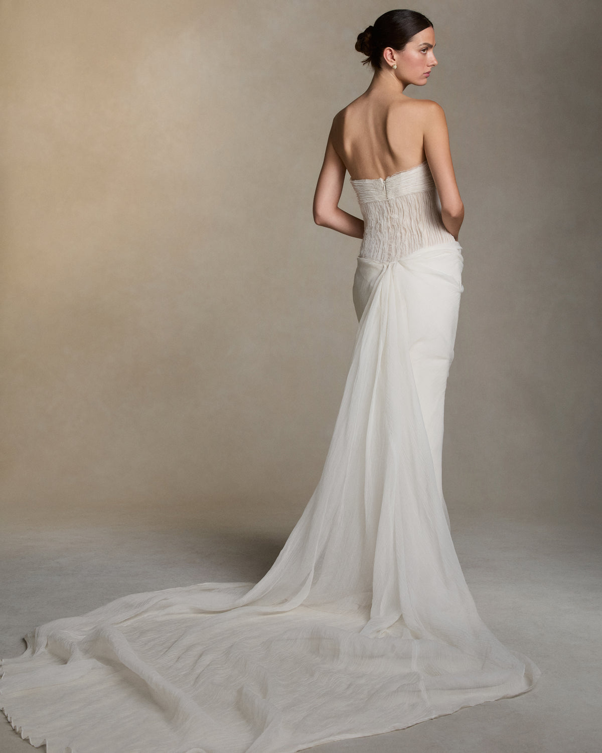 Creppone organza gown with hand painted iris florals at waist. Ivory creppone organza organza bias strip embroidery decorates the nude bobbinette bodice and transparent creppone organza cascades over a silk wool twill column skirt. Invisible zip closure at center back.