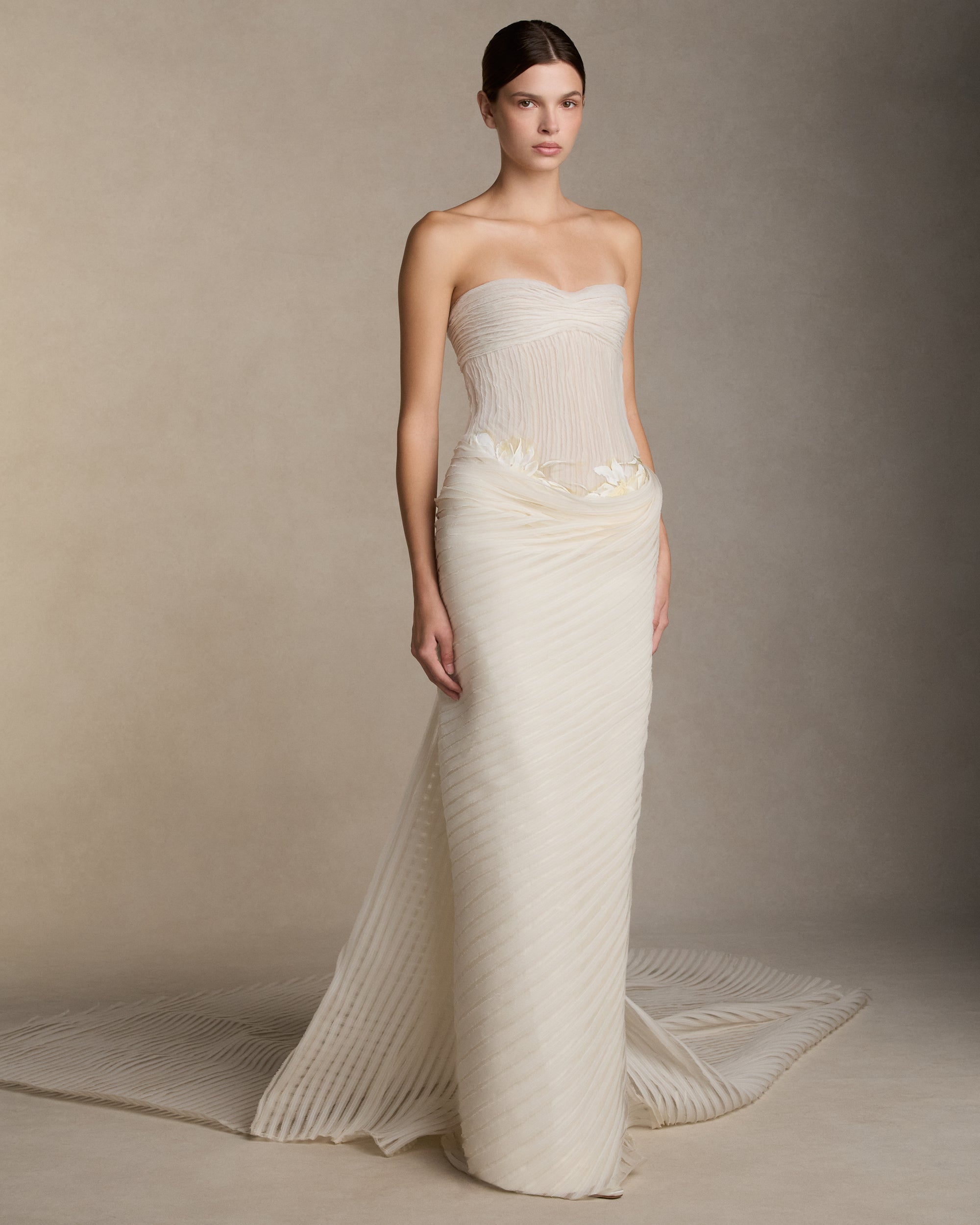 Crinkle organza and chiffon bias strip gown with hand painted iris florals at waist. Ivory crinkle organza organza bias strip embroidery decorates the nude bobinette bodice and transparent chiffon bias strip horsehair embroidery cascades over a silk wool twill column skirt. Invisible zip closure at center back.