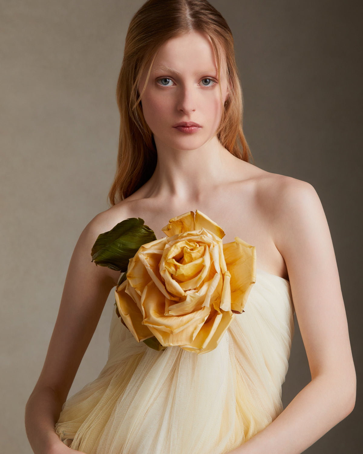 Hand dyed soft tulle dress with delicate hand crafted english rose at bodice. Layer of tulle circle the rose at bust, falling into a swagged skirt. Center back zip. 