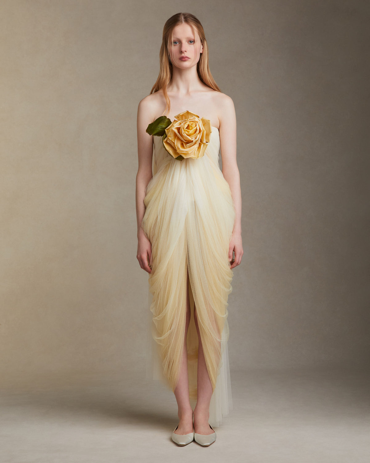 Hand dyed soft tulle dress with delicate hand crafted english rose at bodice. Layer of tulle circle the rose at bust, falling into a swagged skirt. Center back zip. 