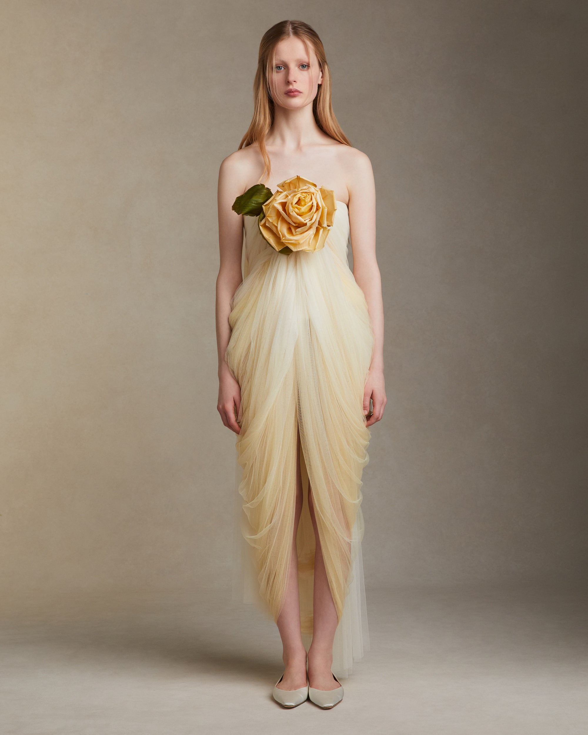 Hand dyed soft tulle dress with delicate hand crafted english rose at bodice. Layer of tulle circle the rose at bust, falling into a swagged skirt. Center back zip. 