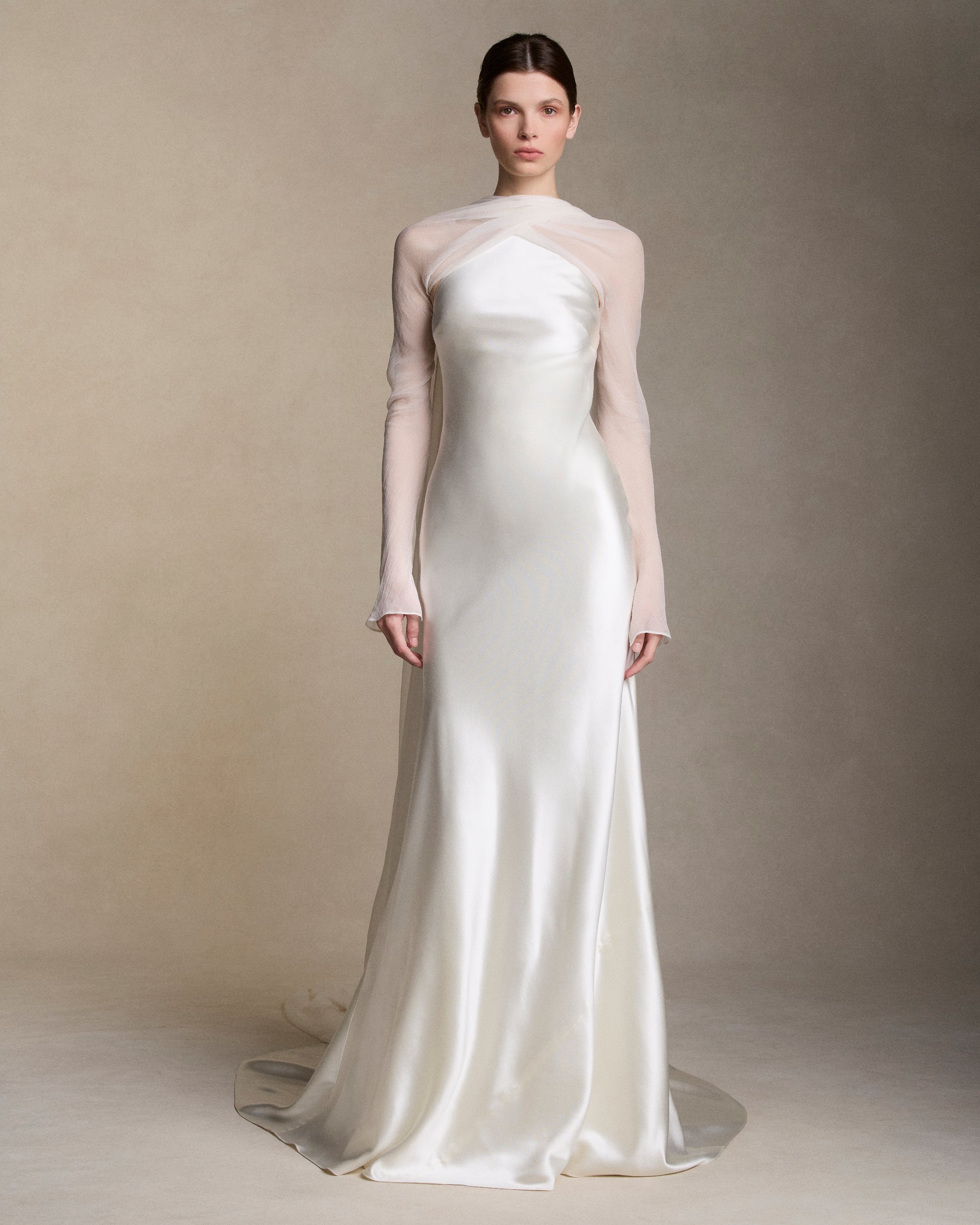 Removable tulle sleeves drape across center front falling into a scarf train detail at center back.  