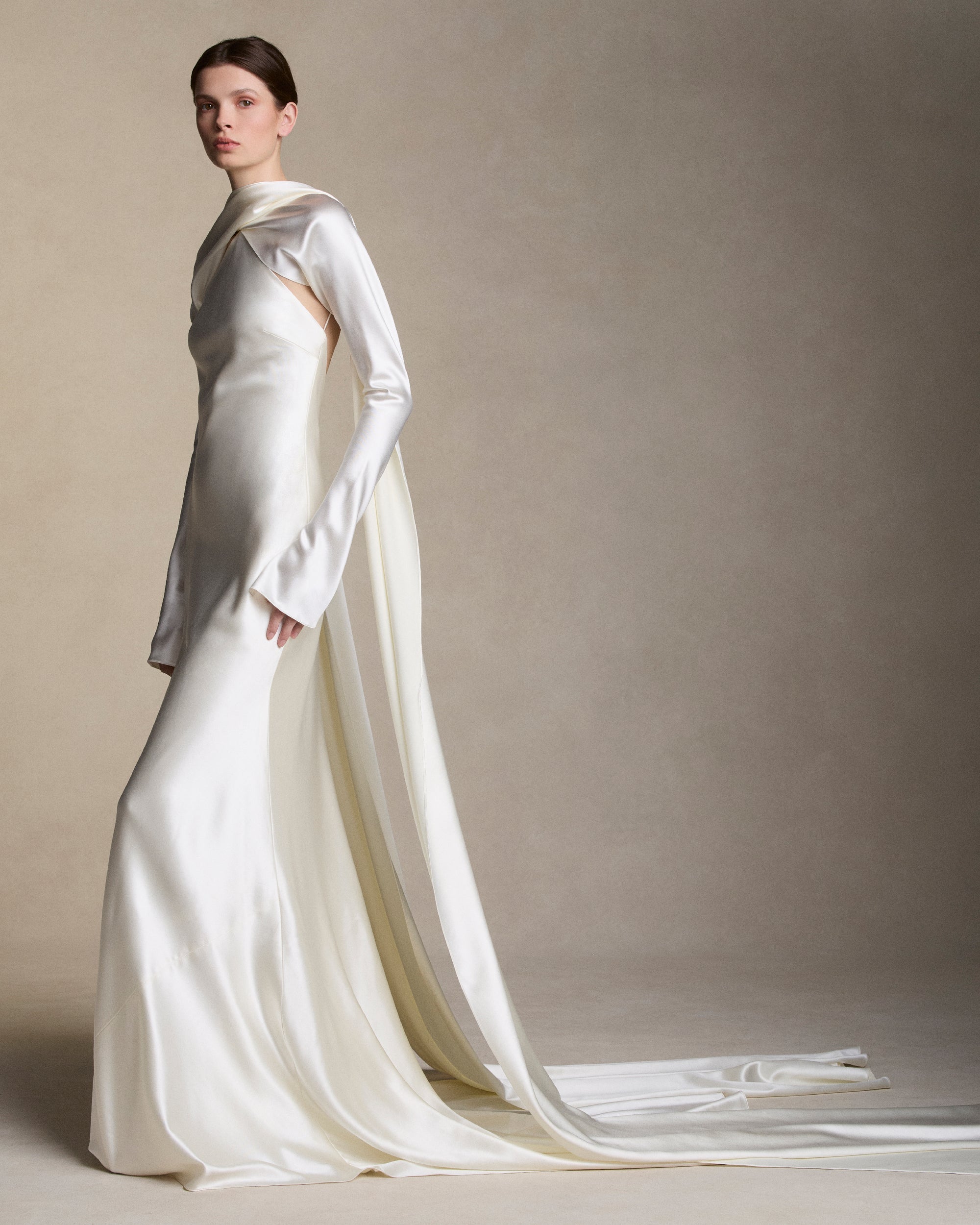 Removable tulle sleeves drape across center front falling into a scarf train detail at center back.  
