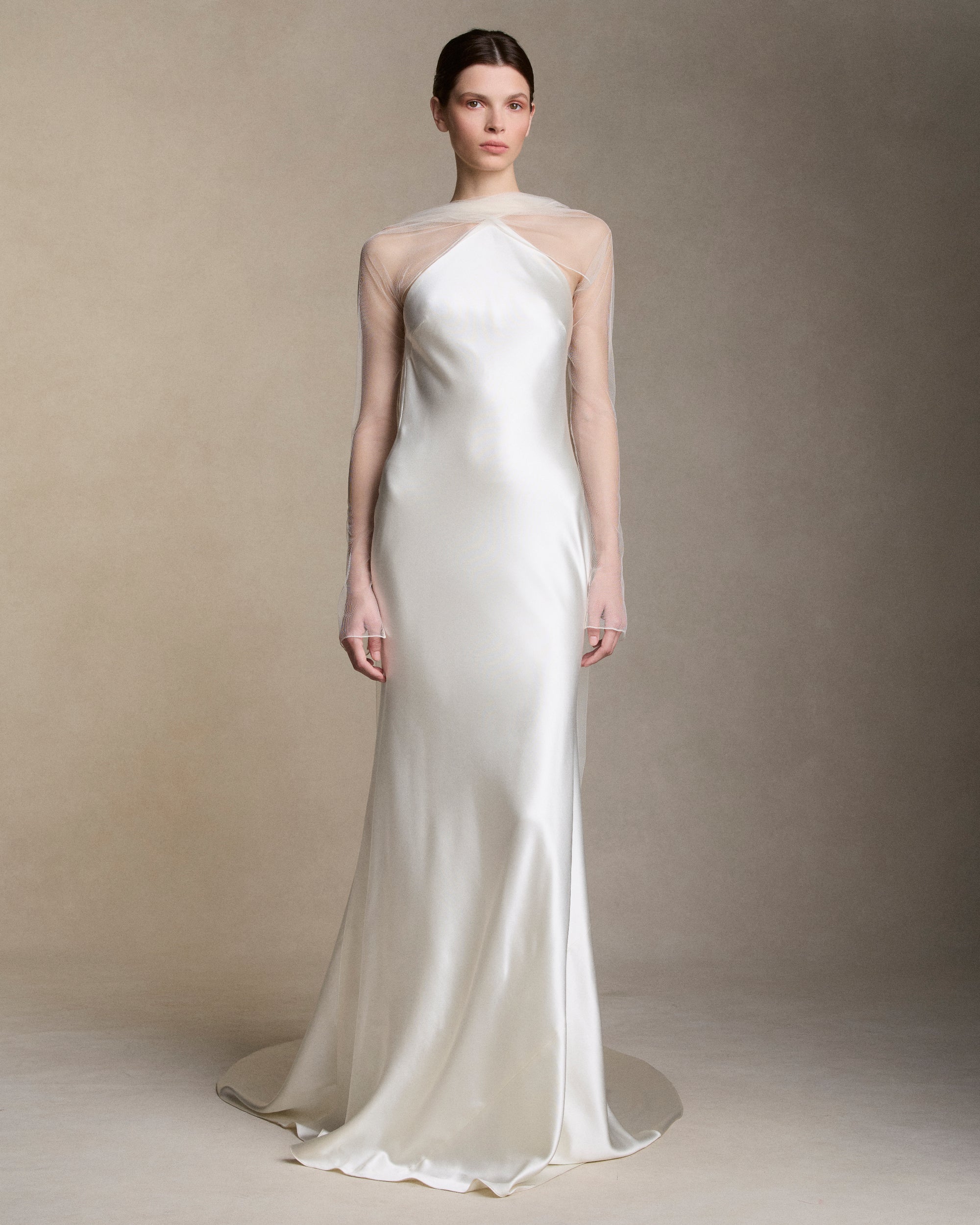 Removable tulle sleeves drape across center front falling into a scarf train detail at center back.  