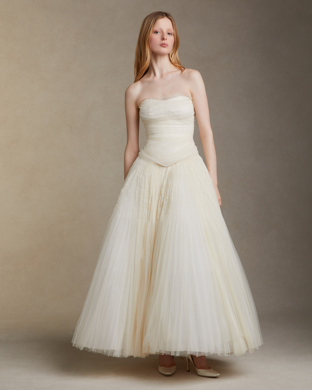 Sunburst pleated hand crinkled soft tulle ball skirt with cotton twill basque waist yoke. Center back zip closure.Styled with Georgia Bustier & Baroque Pearl StudsStyled with Milo Bustier