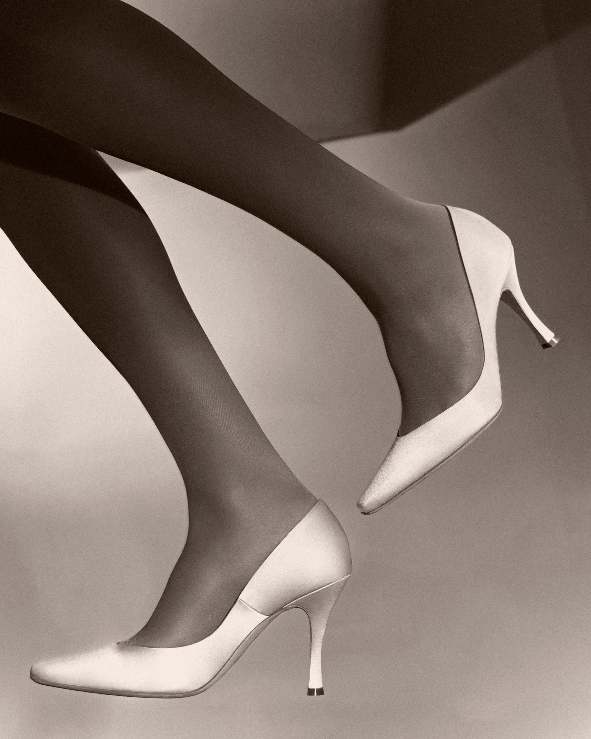  Sleek rounded square toe classic pump crafted in Italy of ivory satin. 90mm heel. 