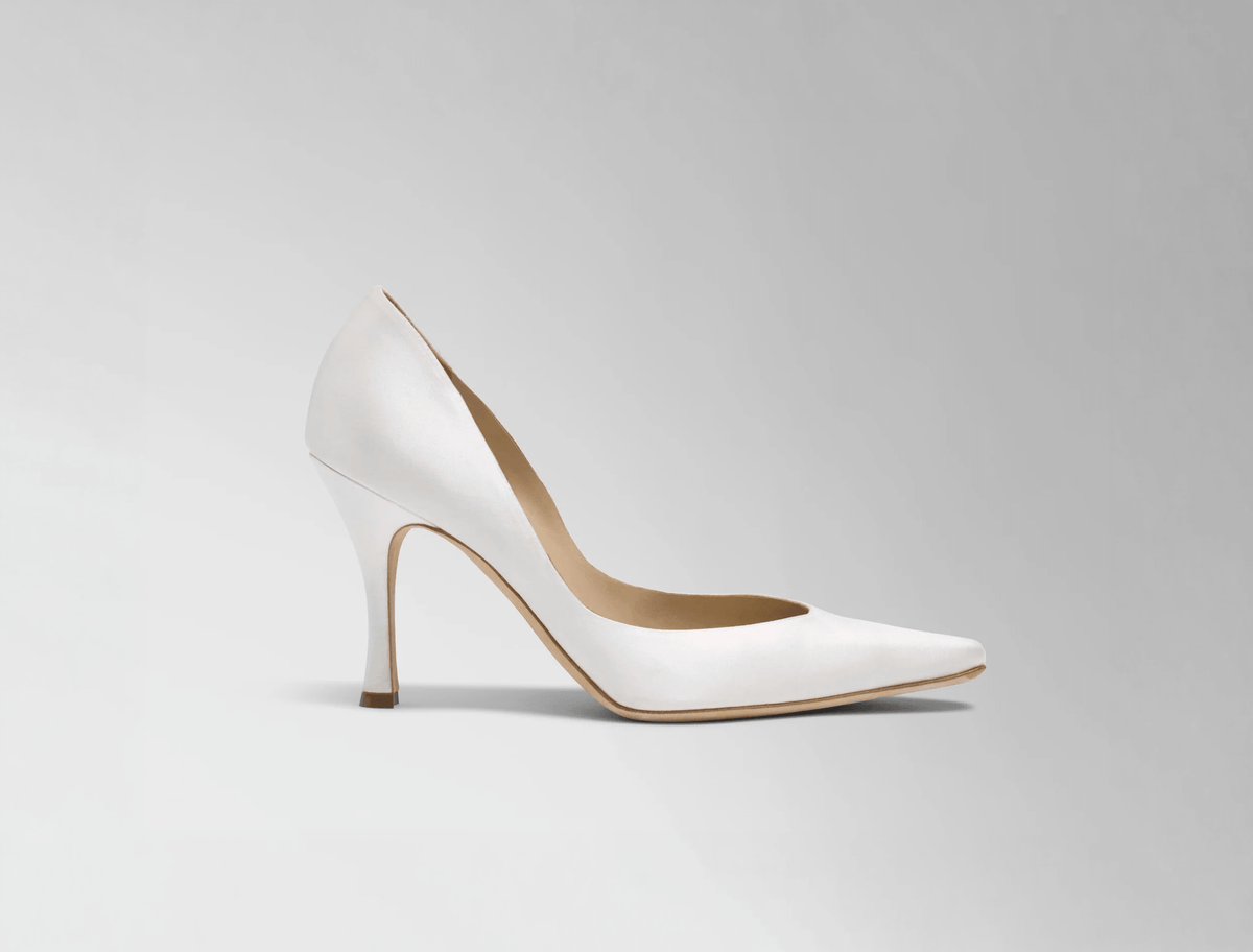  Sleek rounded square toe classic pump crafted in Italy of ivory satin. 90mm heel. 