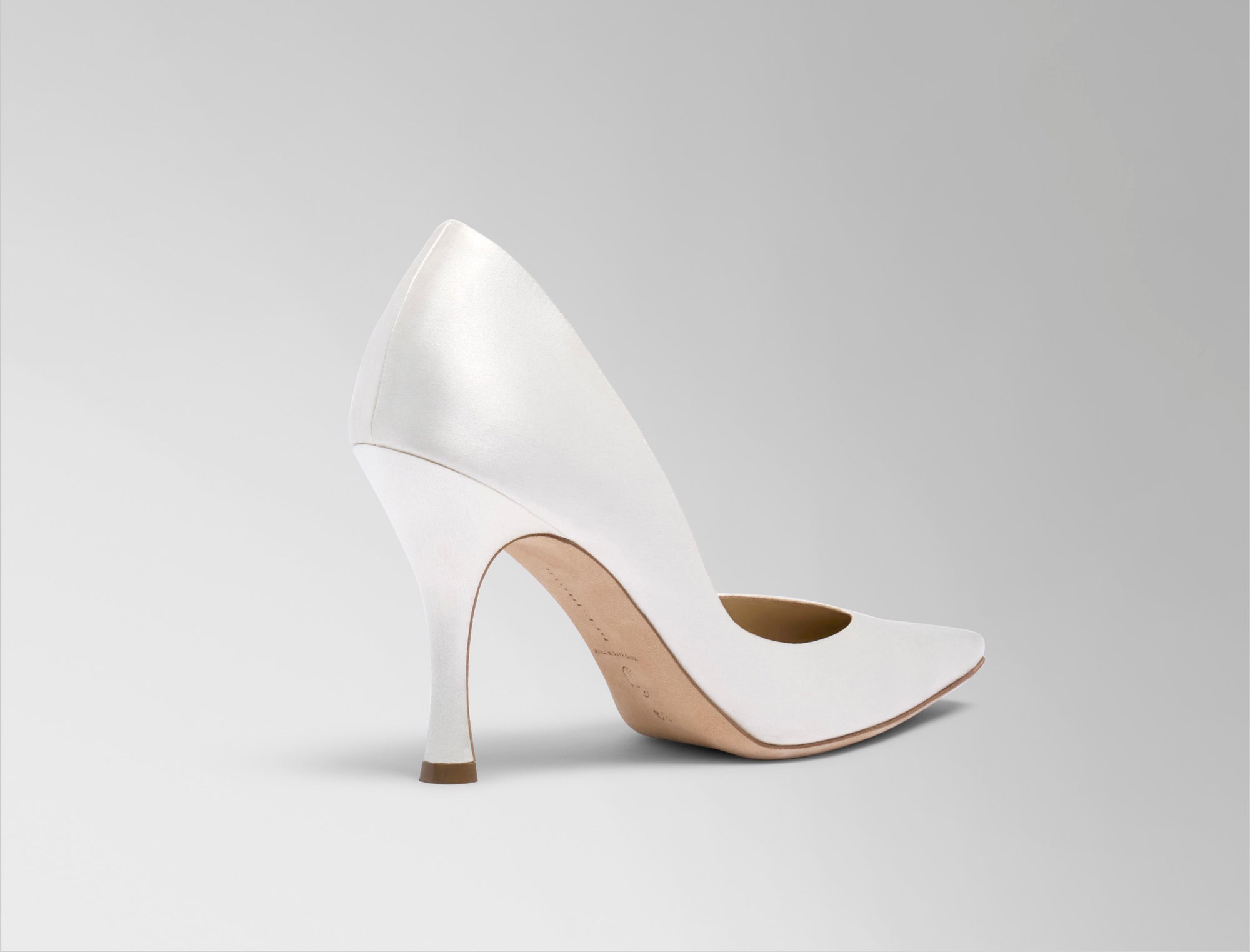  Sleek rounded square toe classic pump crafted in Italy of ivory satin. 90mm heel. 