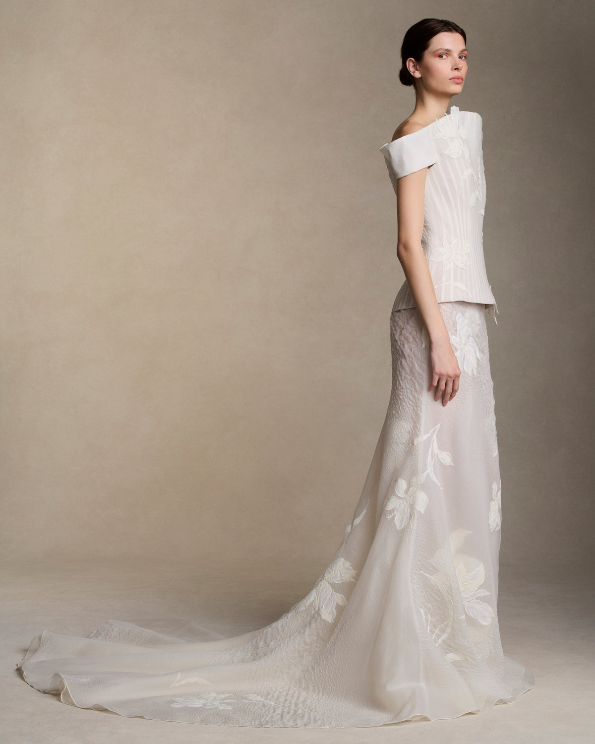 Transparent textured cloqué organza bias cut skirt with train decorated with organza underlay. Hand painted iris appliques scattered throughout. Invisible zip closure at center back.Styled with Veda bustier